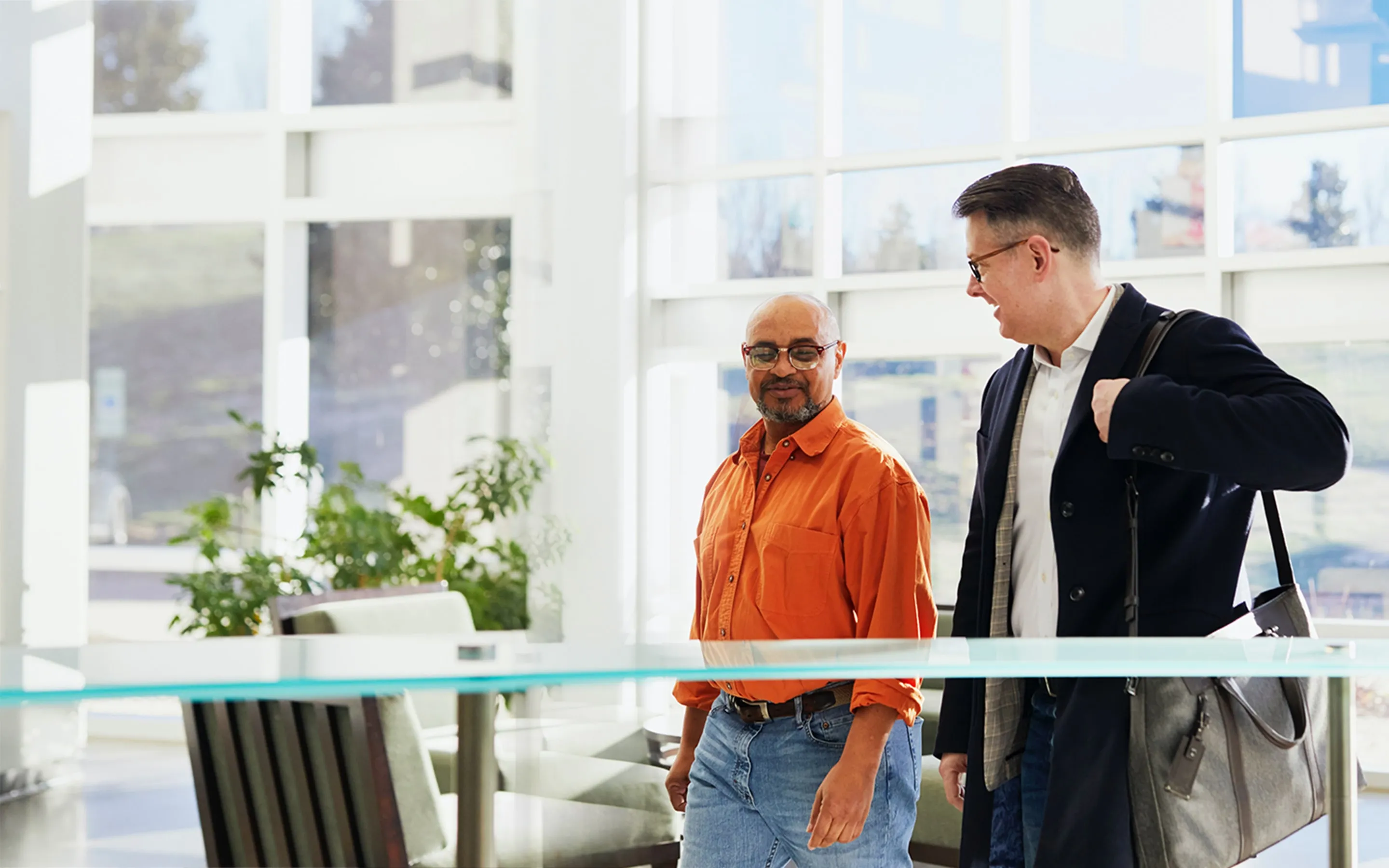 two men walking into office