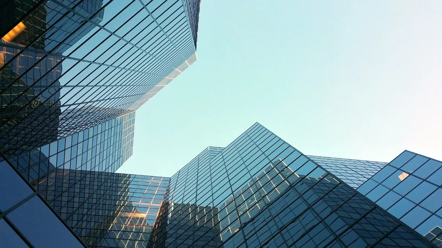 view of a corporate building from the ground, looking up to the sky