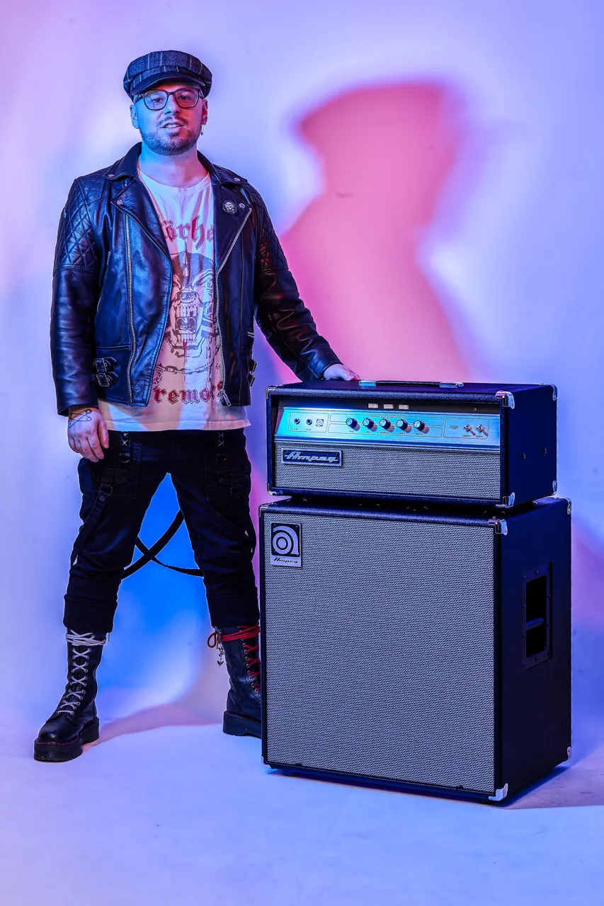 Studio portrait of a man in a leather jacket and flat cap, taken at Dock Street Studio in Leeds