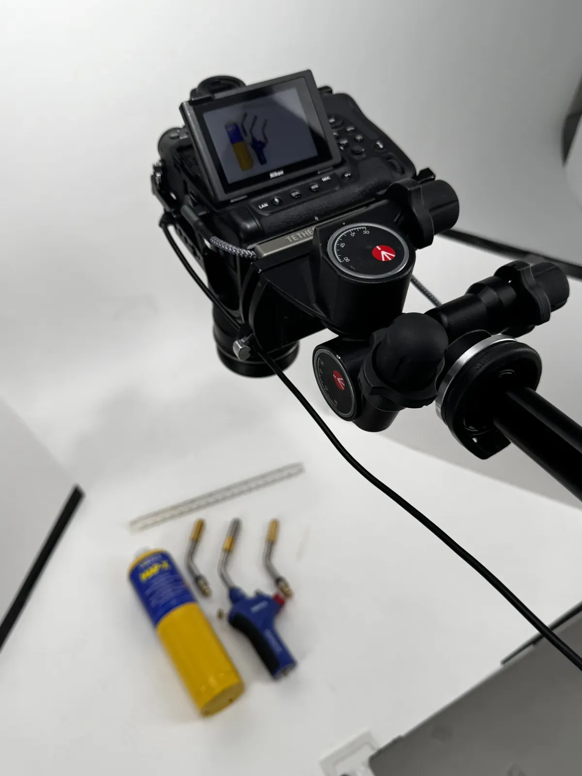 Nikon camera on a Manfrotto geared head, tethered and shooting down onto a white sweep for small product photography at Dock Street Studio, Leeds