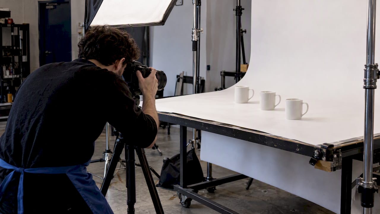 Identical mugs lined up for consistent ecommerce product photography