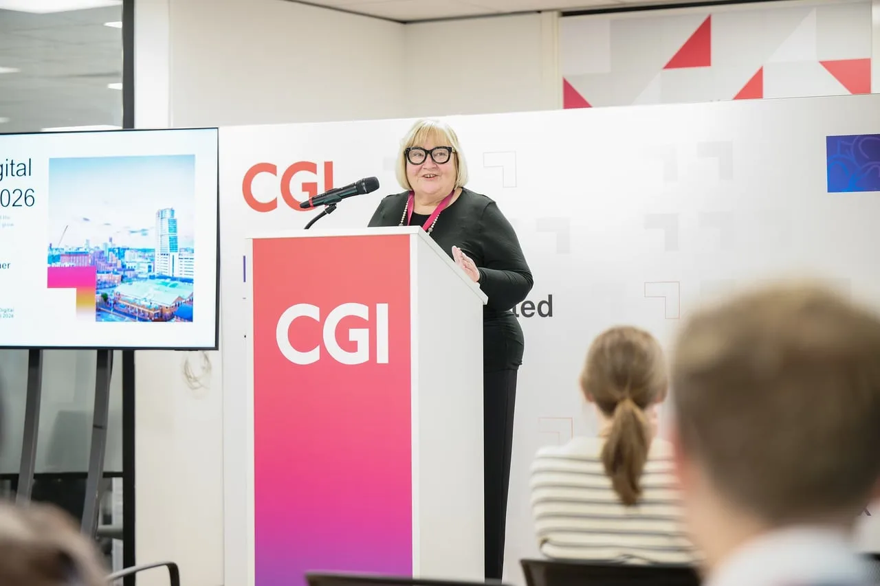 Speaker at the red CGI lectern opening SMEs Growing Together, hosted by CGI for Leeds Digital Festival in Leeds — event photography by Dock Street Studio, Leeds
