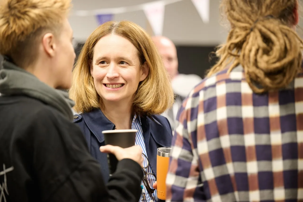 Delegate smiling during drinks networking at SMEs Growing Together, hosted by CGI for Leeds Digital Festival in Leeds — event photography by Dock Street Studio, Leeds
