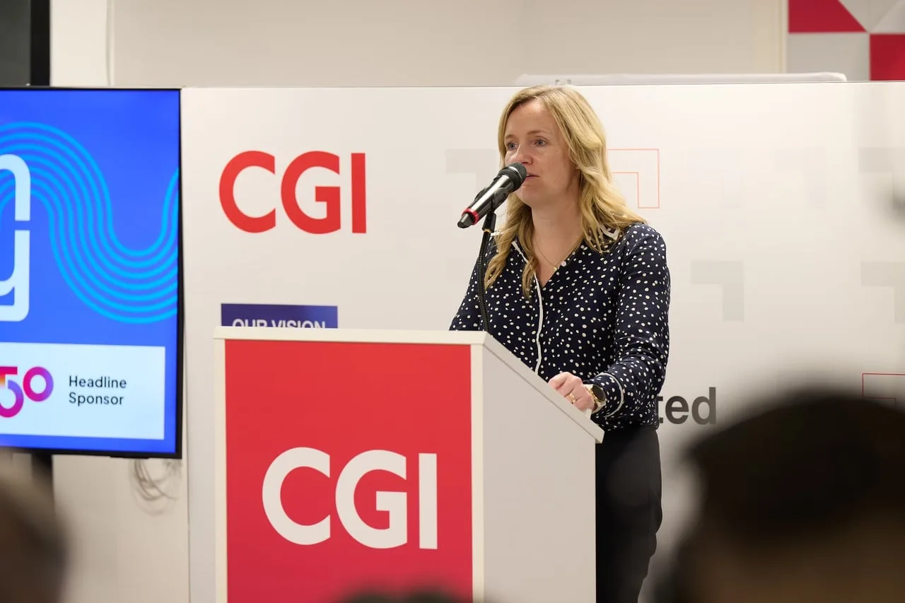Keynote speaker presenting at a red CGI lectern at the Leeds Digital Festival 2026 launch party, hosted by CGI in Leeds — event photography by Dock Street Studio, Leeds