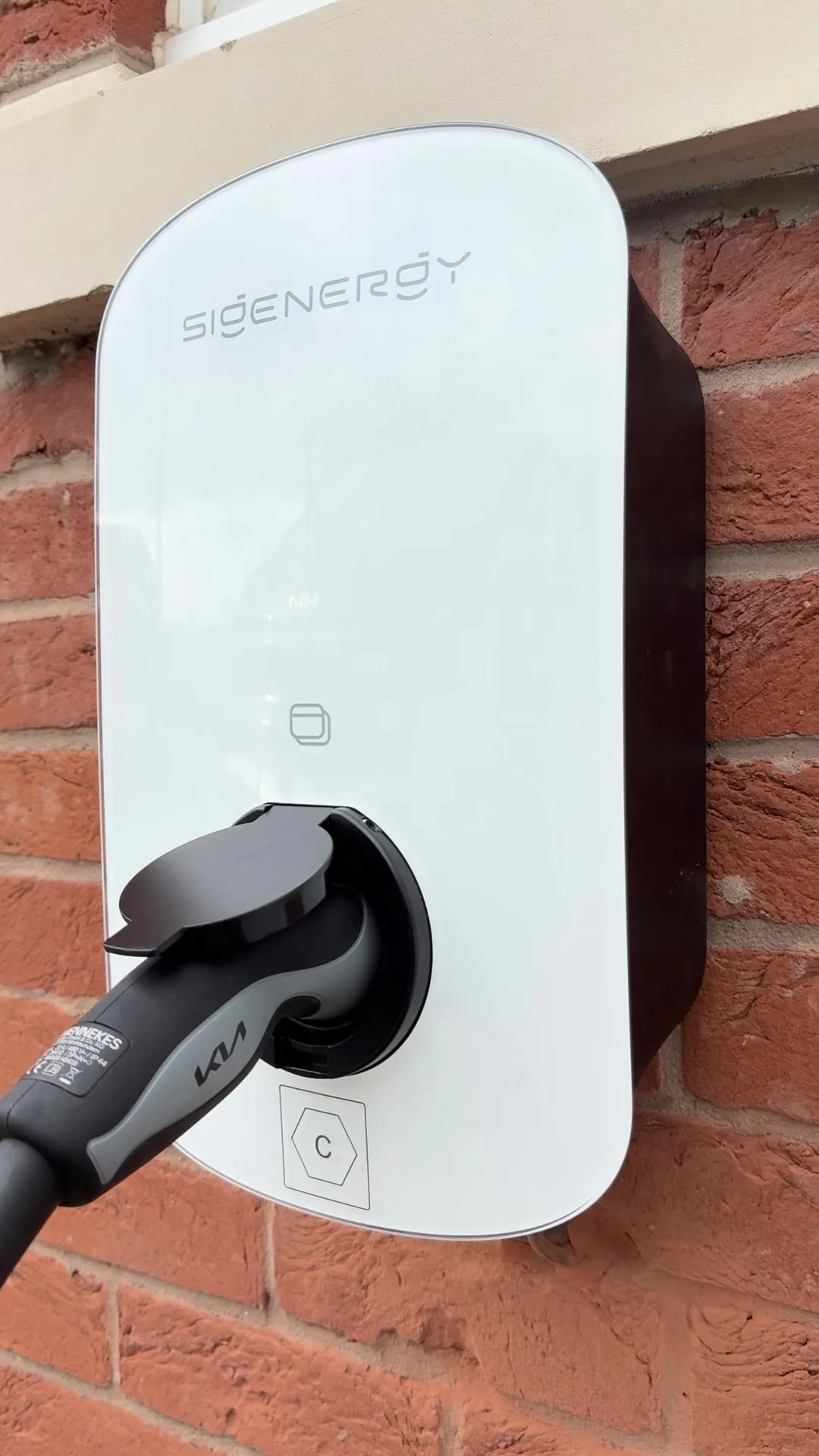 A home EV charger fitted by Bradgate, plugged in and charging