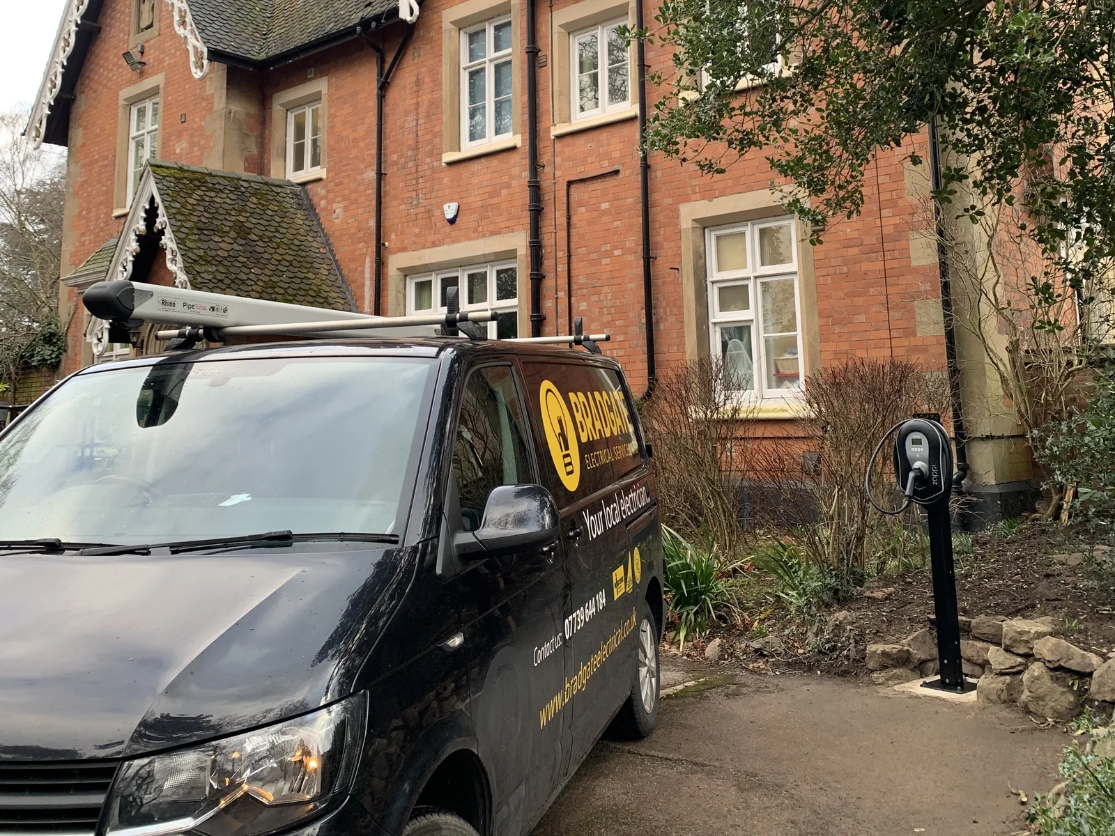 The Bradgate van outside Hardwick House School in Loughborough, with the myenergi Zappi charger on its post by the drive