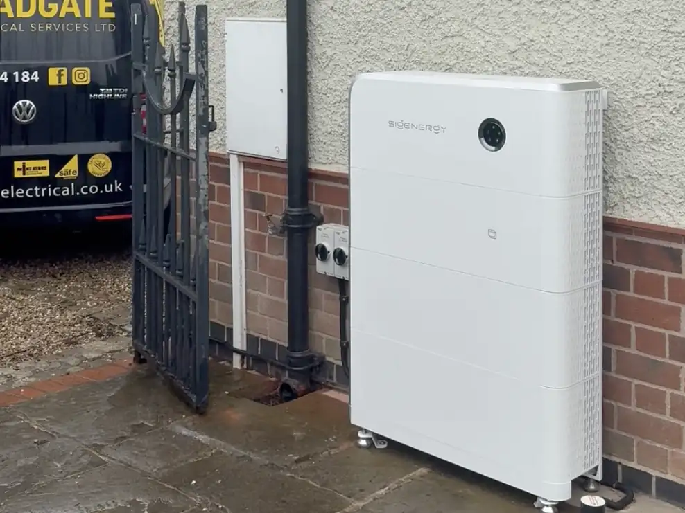 A Sigenergy battery on the side of a house, with a Bradgate Electrical van on the drive