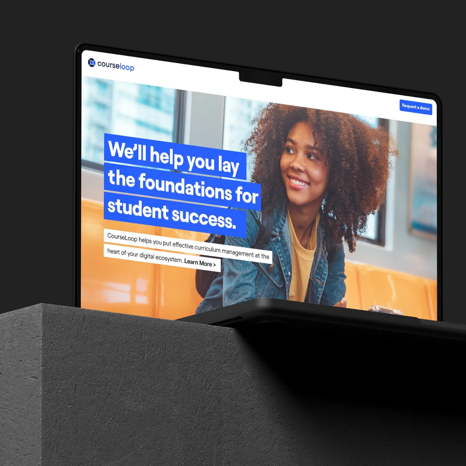 A laptop with a woman on the screen.