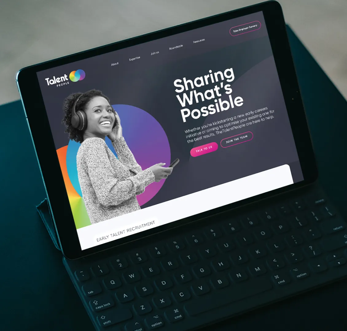 A tablet with a website that says "Sharing what's possible".