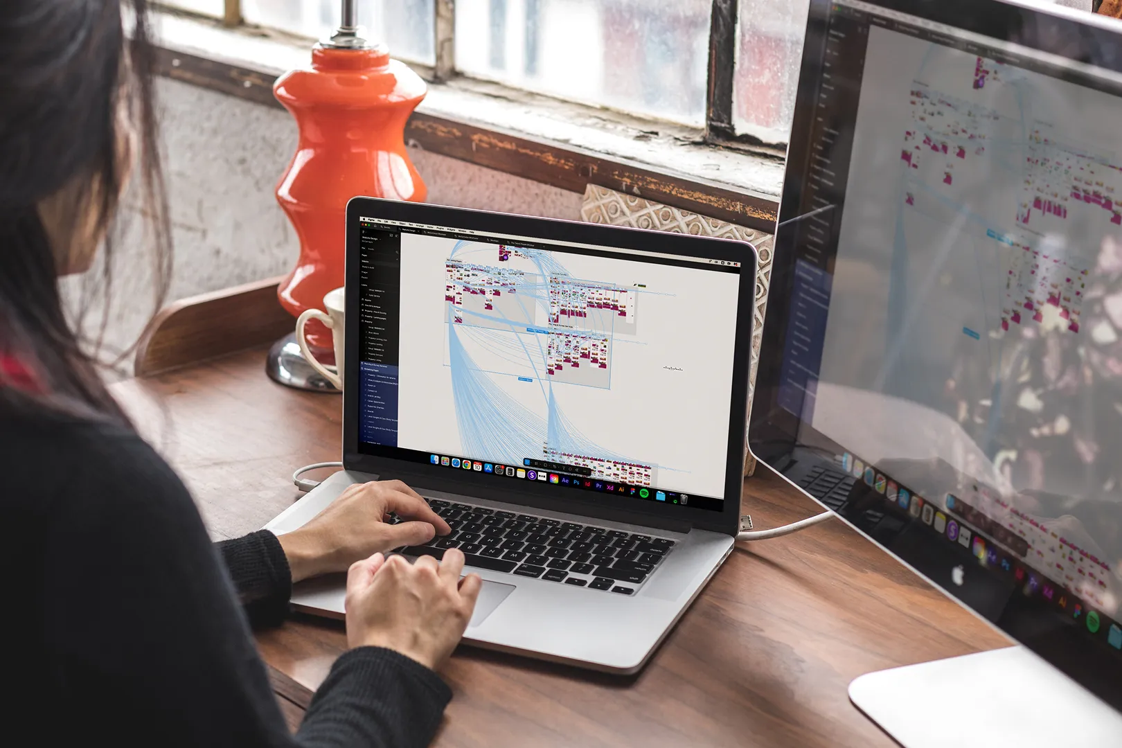 A person is using a laptop with a graphic on the screen.