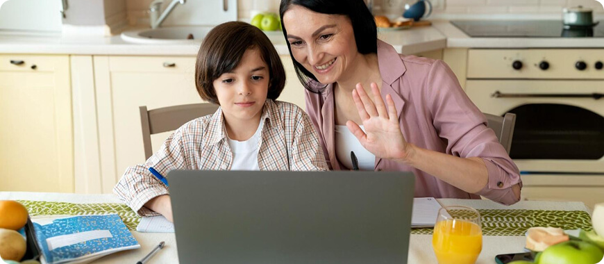 A child and an adult participating in an online English lesson, practicing pronunciation while waving hello during a virtual session.