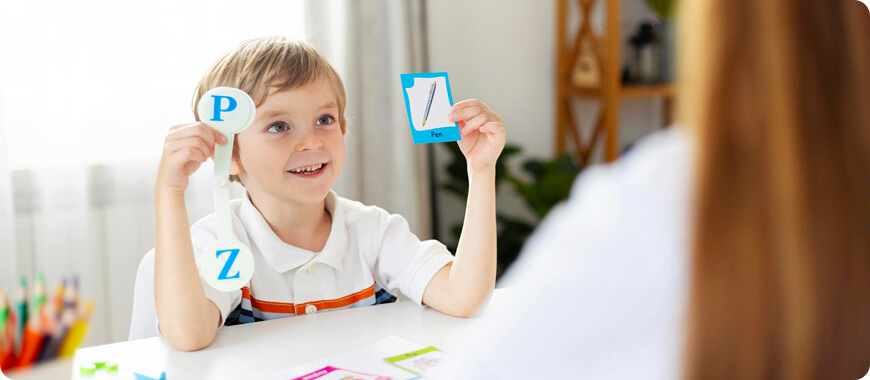 A child holding up letters 'P' and 'Z', participating in an engaging vocabulary activity to learn new English words.