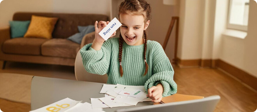 Child playing an English grammar game with flashcards, highlighting fun learning methods