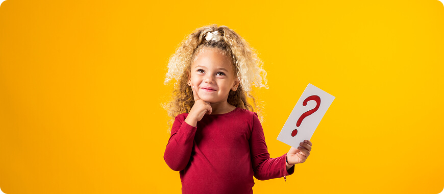 Cute girl holding a question mark — learning how to ask questions in Present Continuous tense for kids