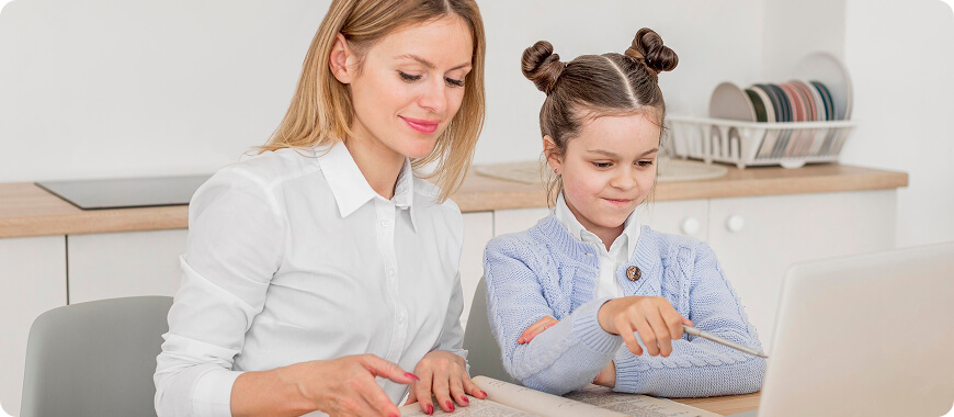 Family Movie Night = English Practice! Mom and kid learning together with fun films. TMother and daughter watching a movie together on a laptop — great way to practice English listening