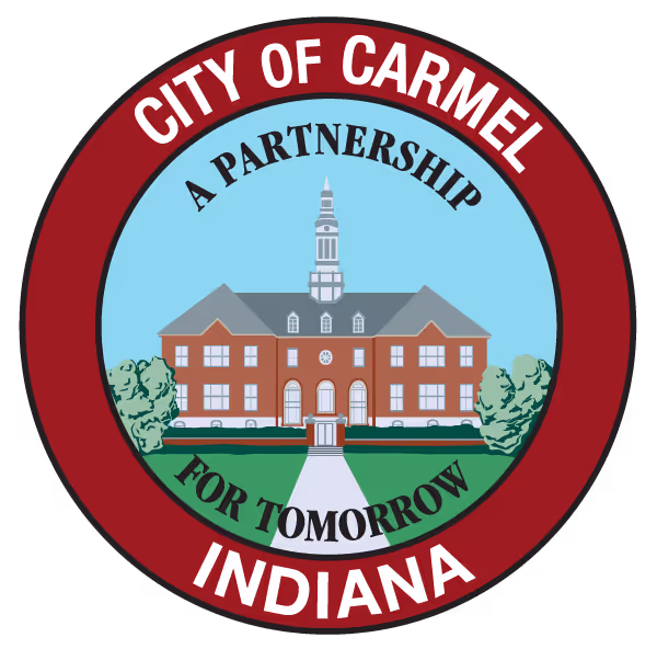 Seal of City of Carmel Indiana featuring a brick building with a steeple and slogan A Partnership for Tomorrow.