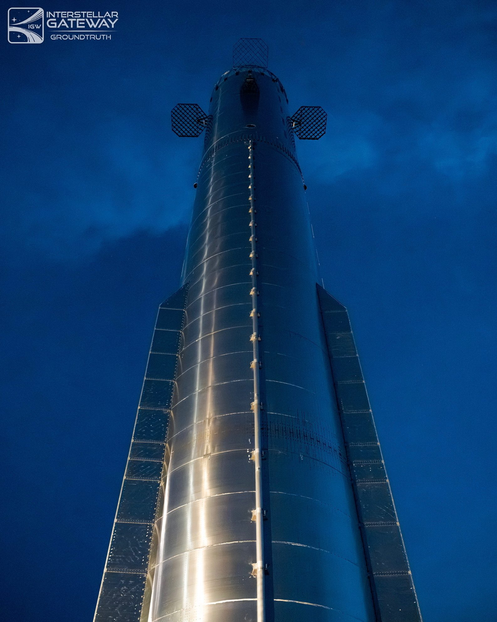 Starship on the launch mount, looking straight up the stainless hull.