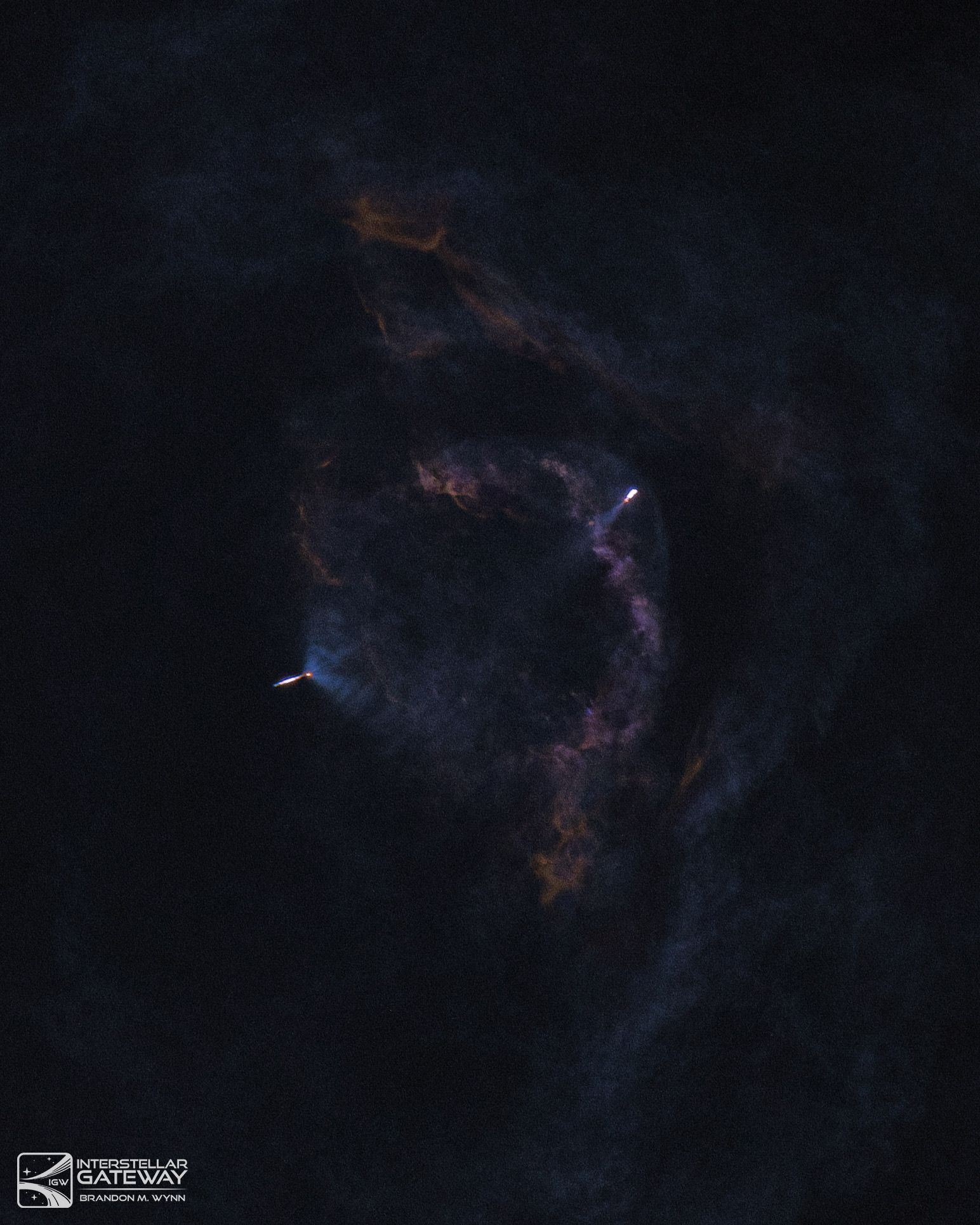 A faint luminous plume high in a dark sky.