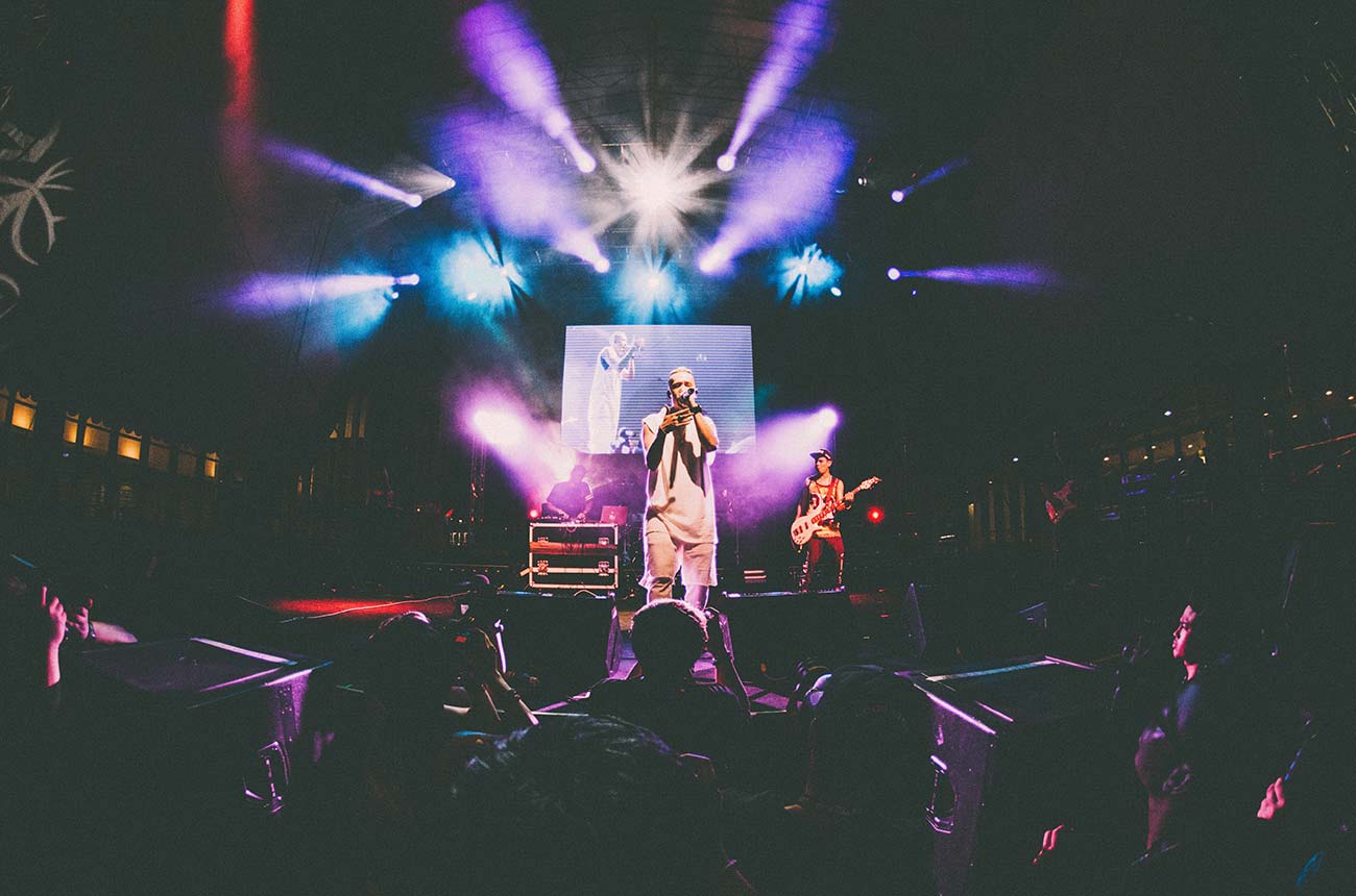 a man standing on a stage in front of a crowd