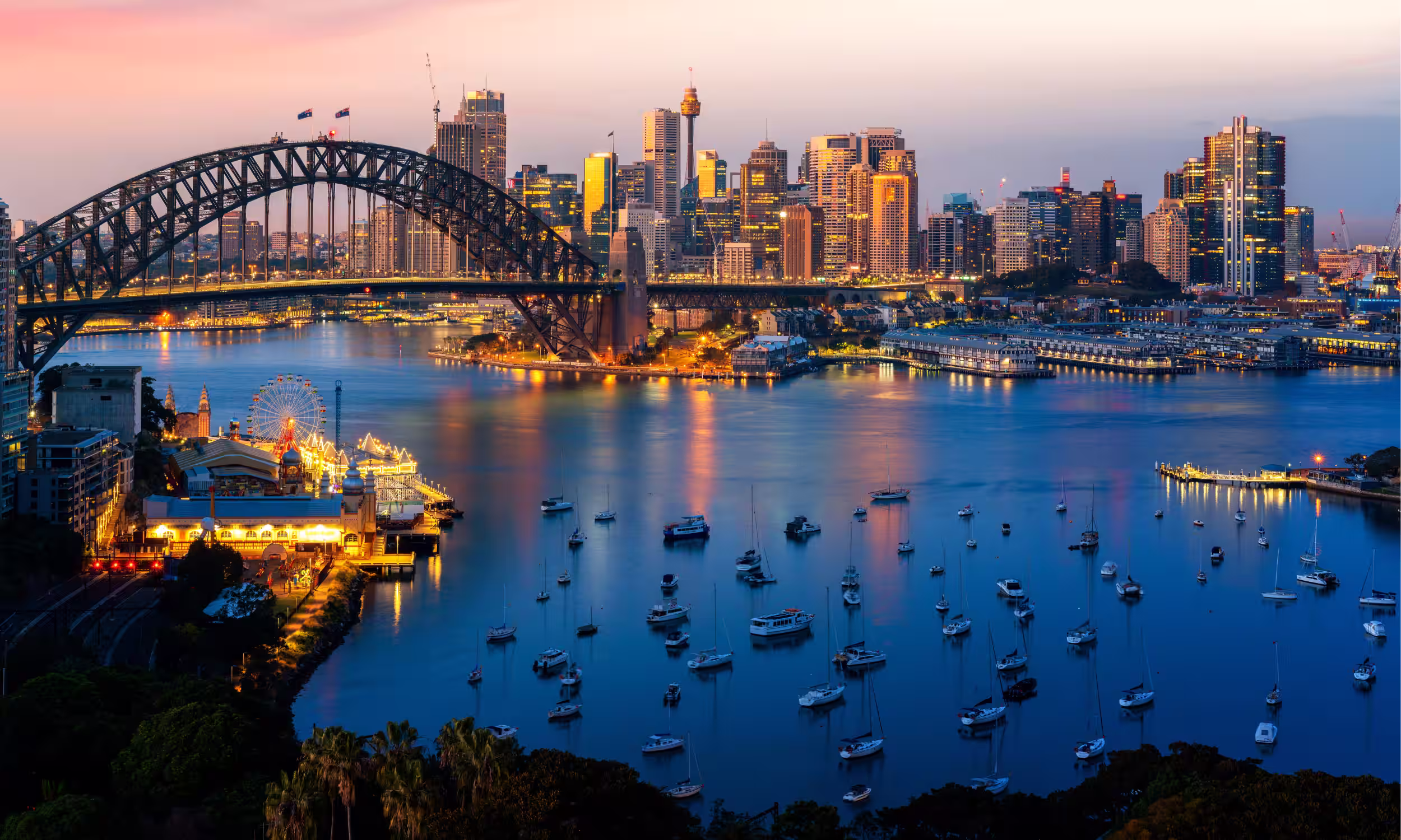 Darling Harbour in Sydney at night with romantic reflections on the water.