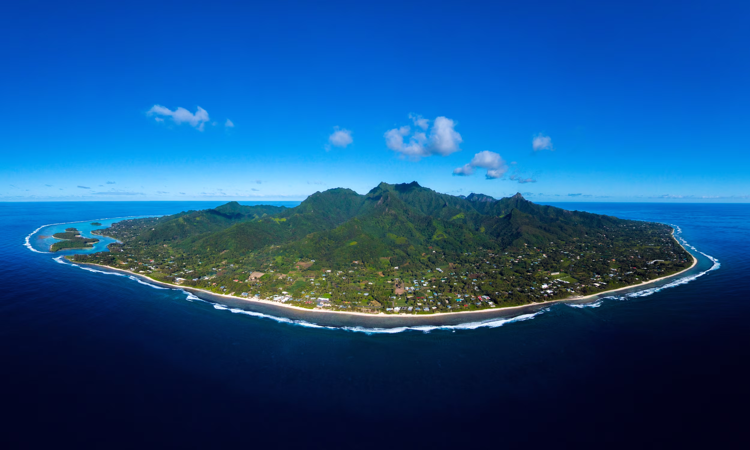 Aerial view of Rarotonga, Cook Islands, surrounded by coral reefs.