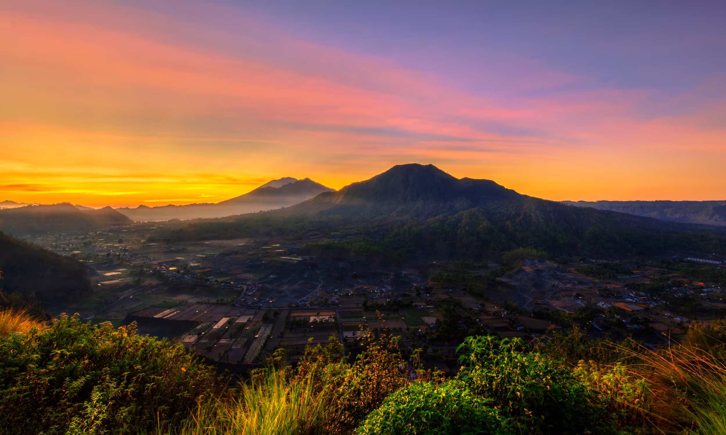 Sunrise over Mount Batur, Bali, during a romantic early-morning hike. 