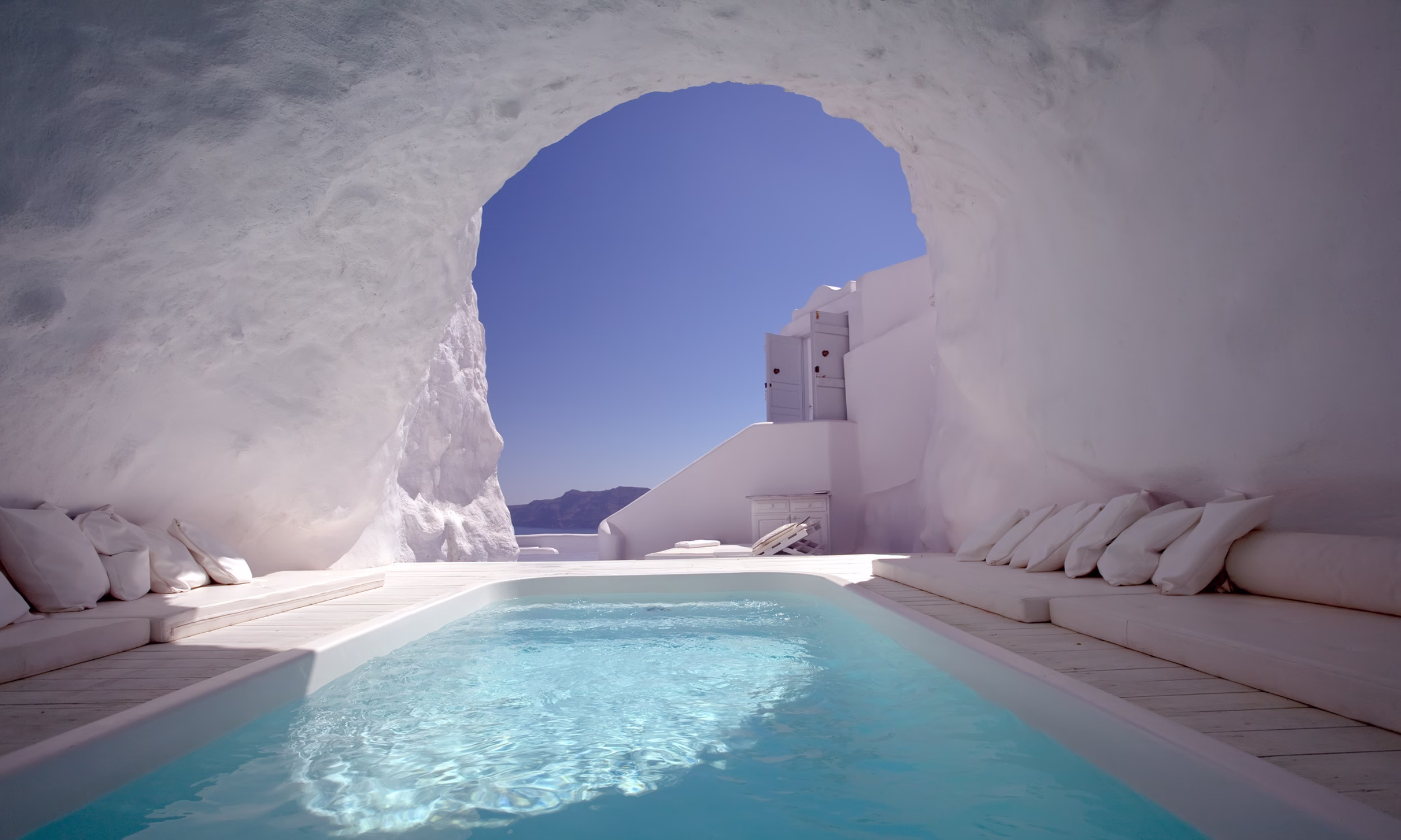 Private cave pool in a luxury Santorini suite overlooking the Aegean Sea. 