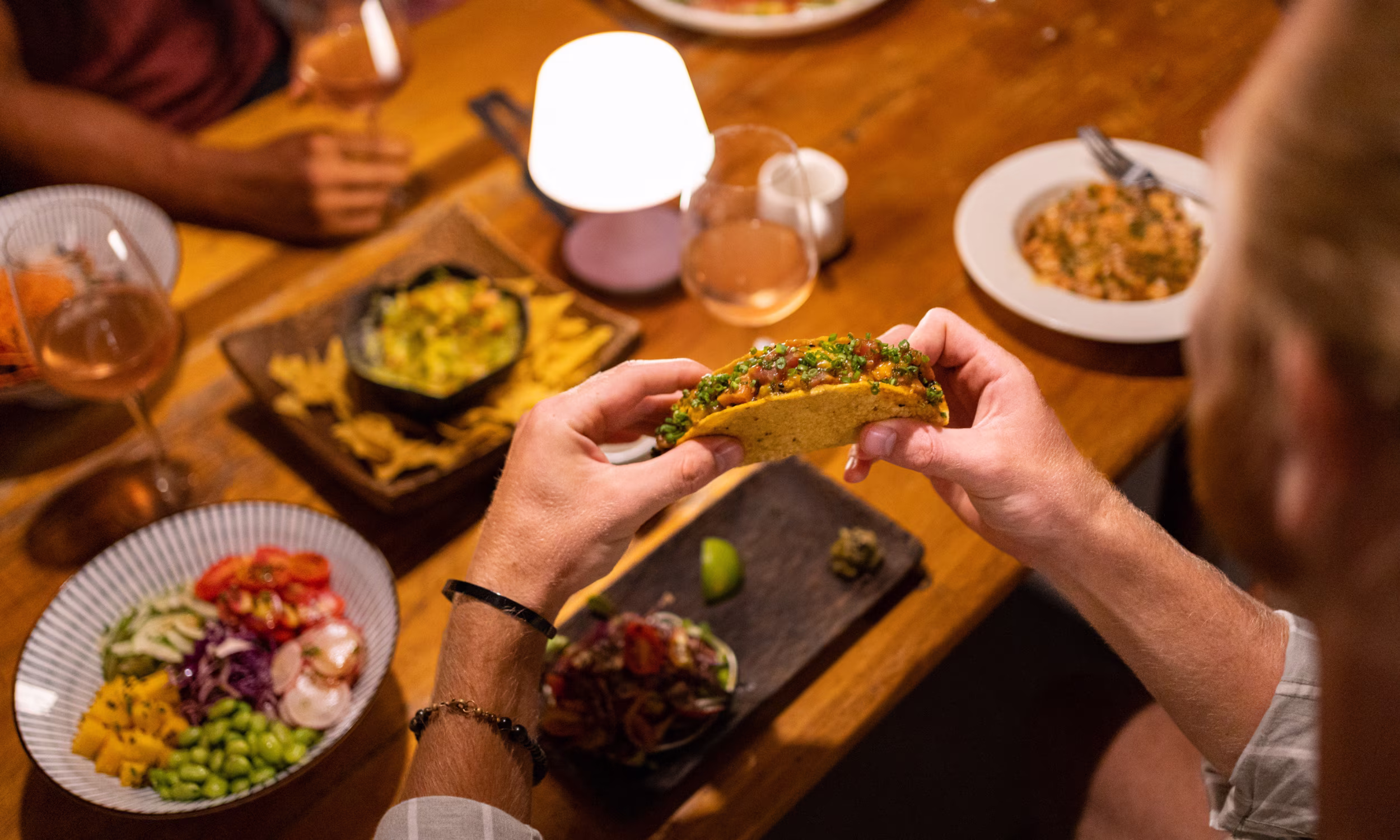 Couple enjoying traditional Mexican cuisine during a romantic dinner. 