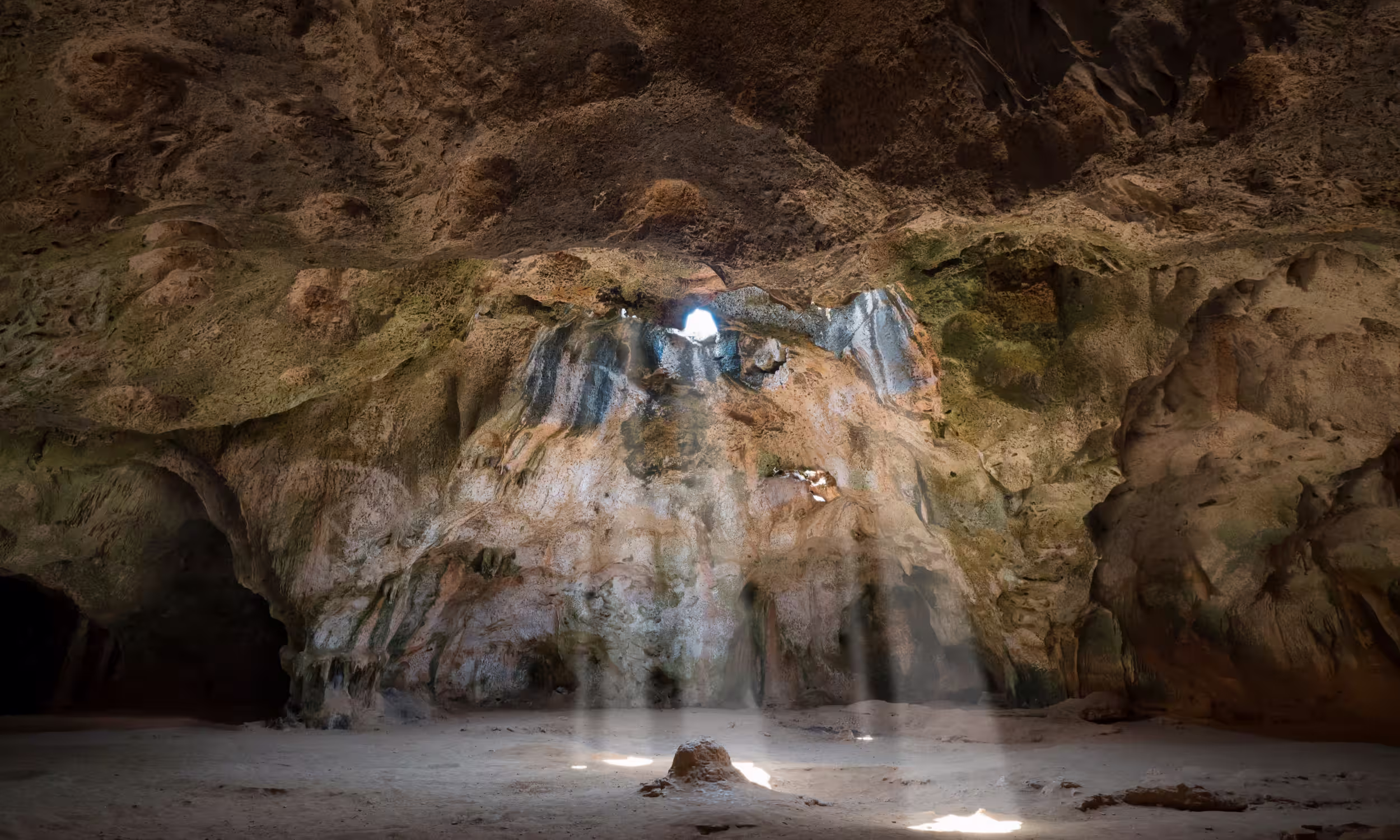 Sunlight beams illuminating the Fontein Cave in Arikok National Park, Aruba.