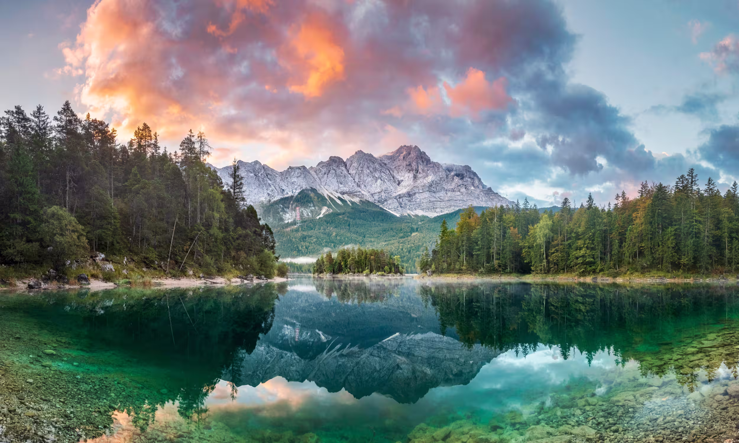 Lake Eibsee with a view of Zugspitze mountain at a colorful sunrise. 
