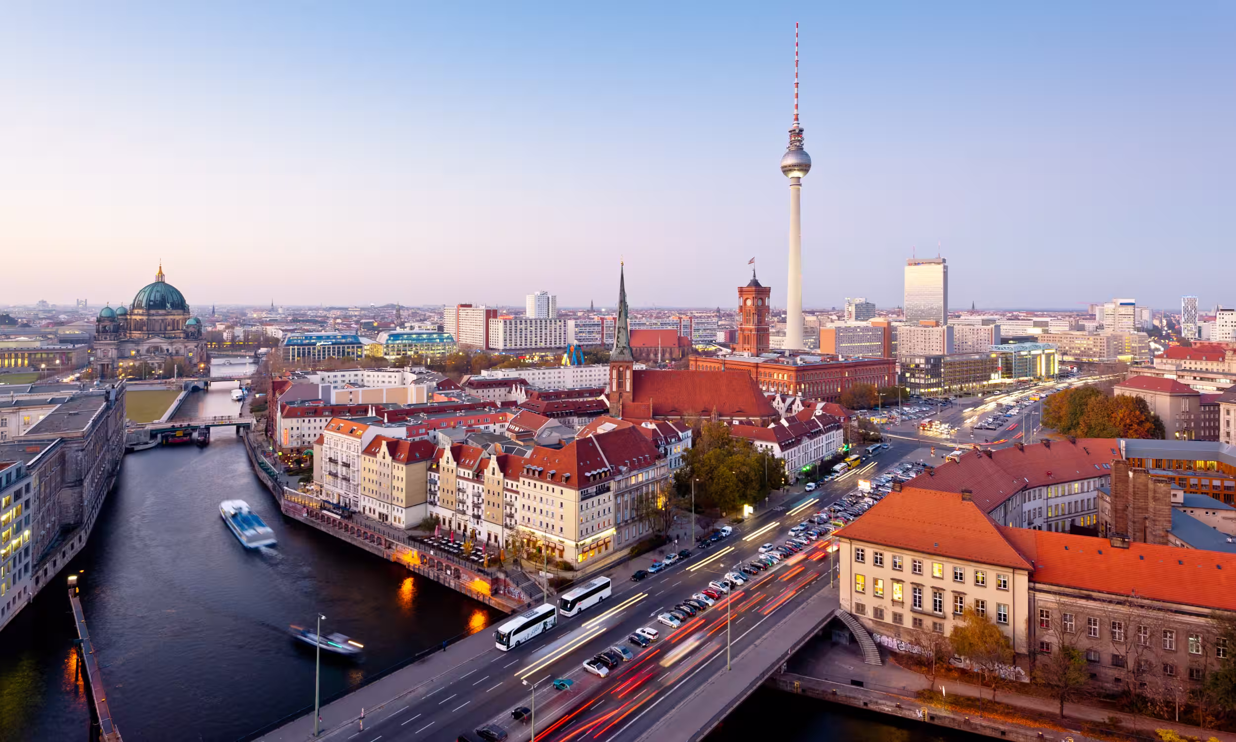 Panoramic view of Berlin with the TV Tower and the Spree River at dusk. 