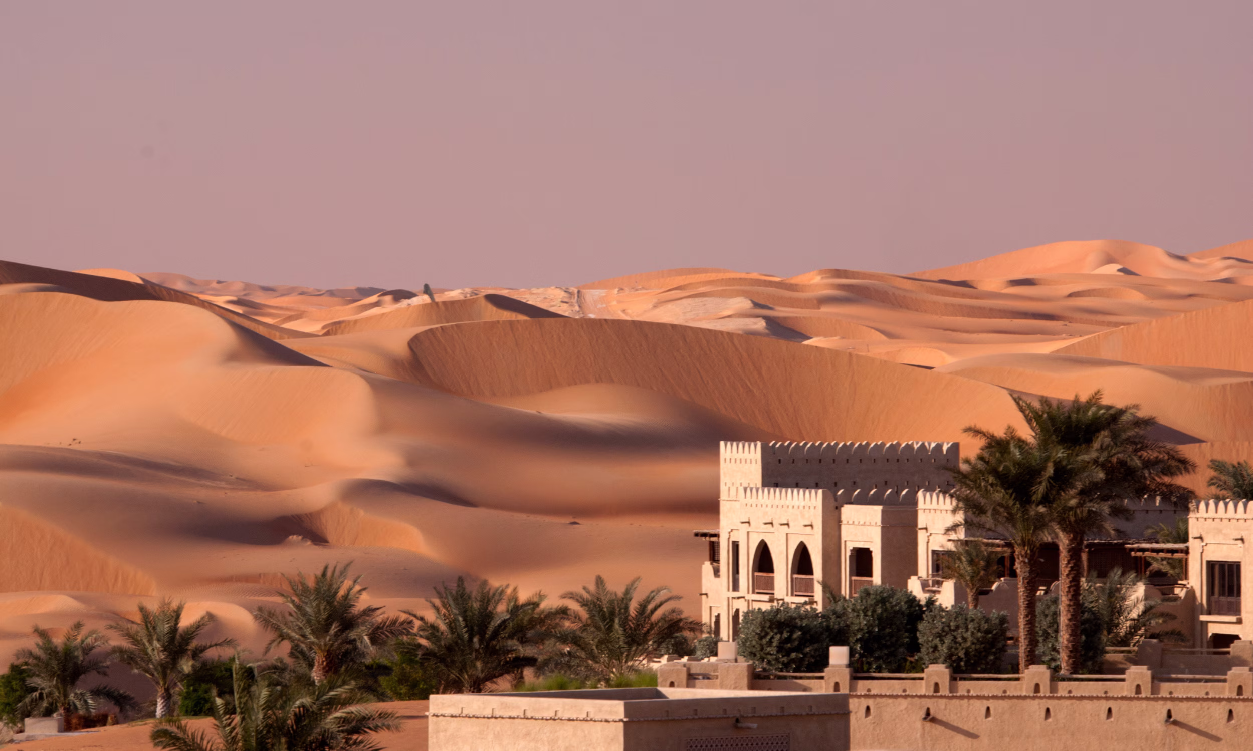 Qasr Al Sarab Desert Resort surrounded by golden dunes — a dreamy Abu Dhabi honeymoon retreat.