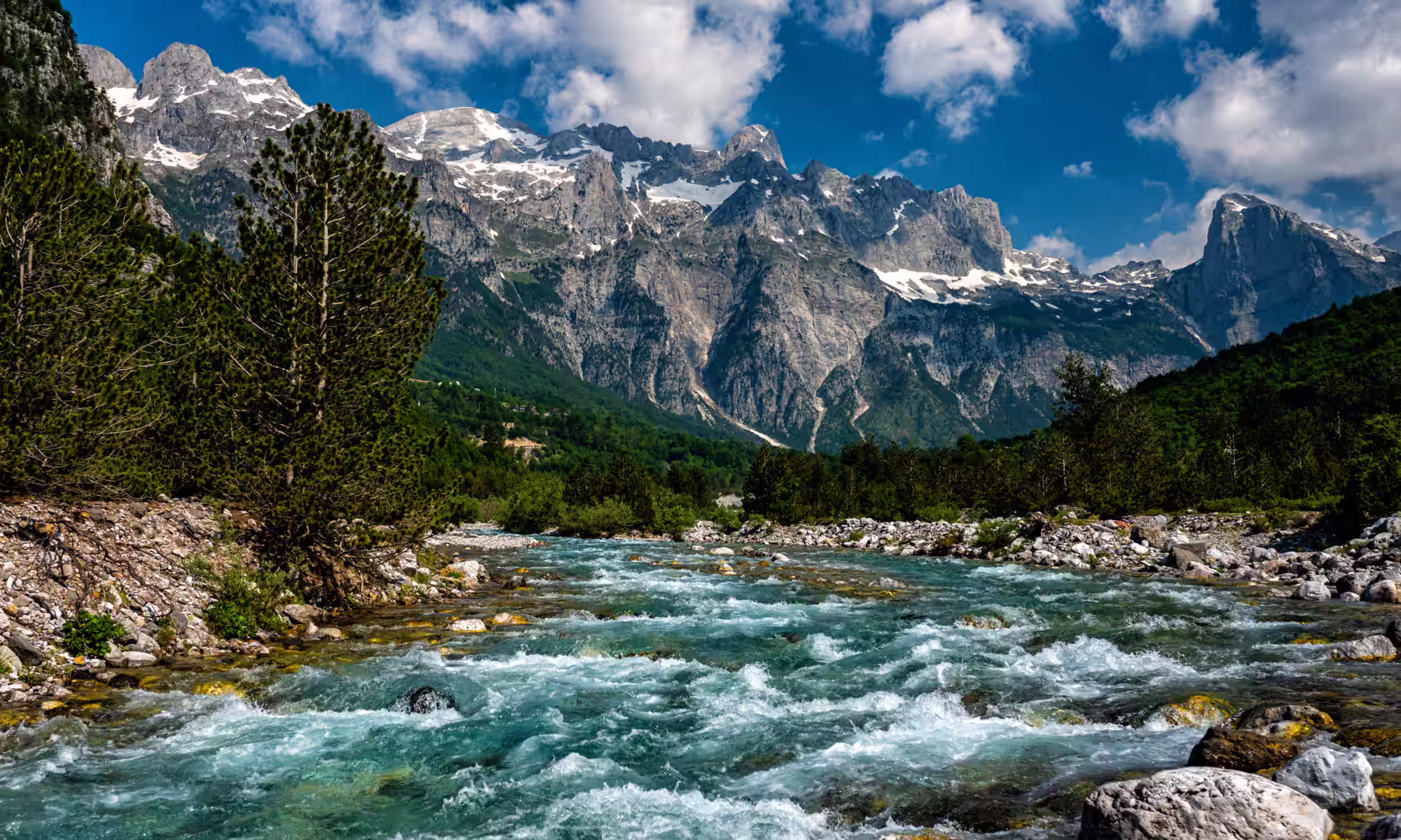 Crystal river running through the Prokletije Mountains — wild nature of the Albanian Alps. 