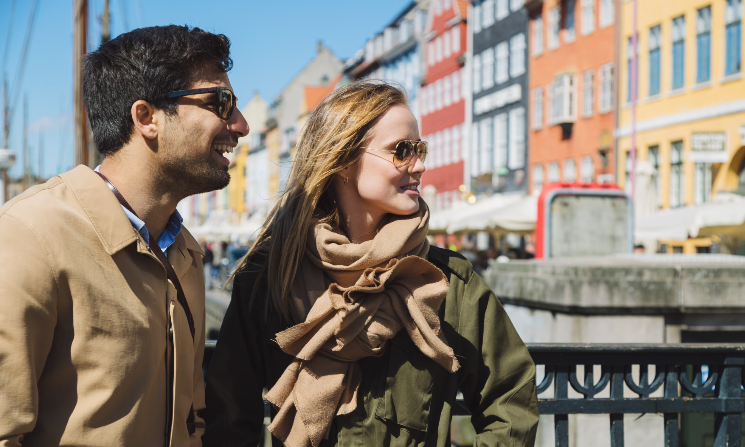 Honeymoon couple walking by the Nyhavn canal in Copenhagen. 