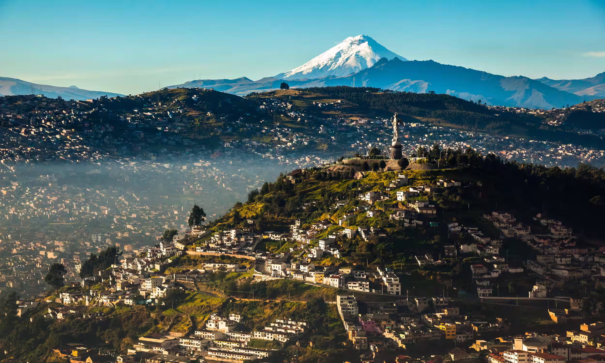 Panoramic view of Quito from El Panecillo with the Andes mountains in the background. 