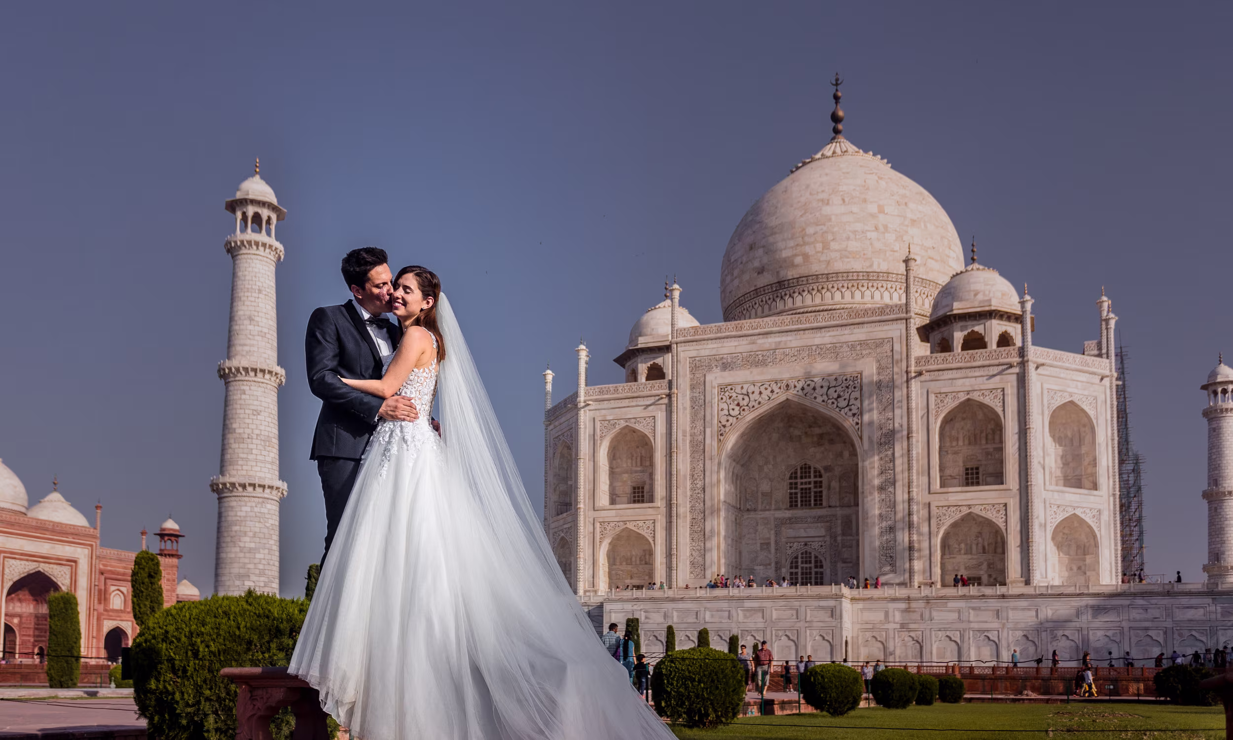 Elegant couple in front of the Taj Mahal celebrating love during a luxury honeymoon in India.