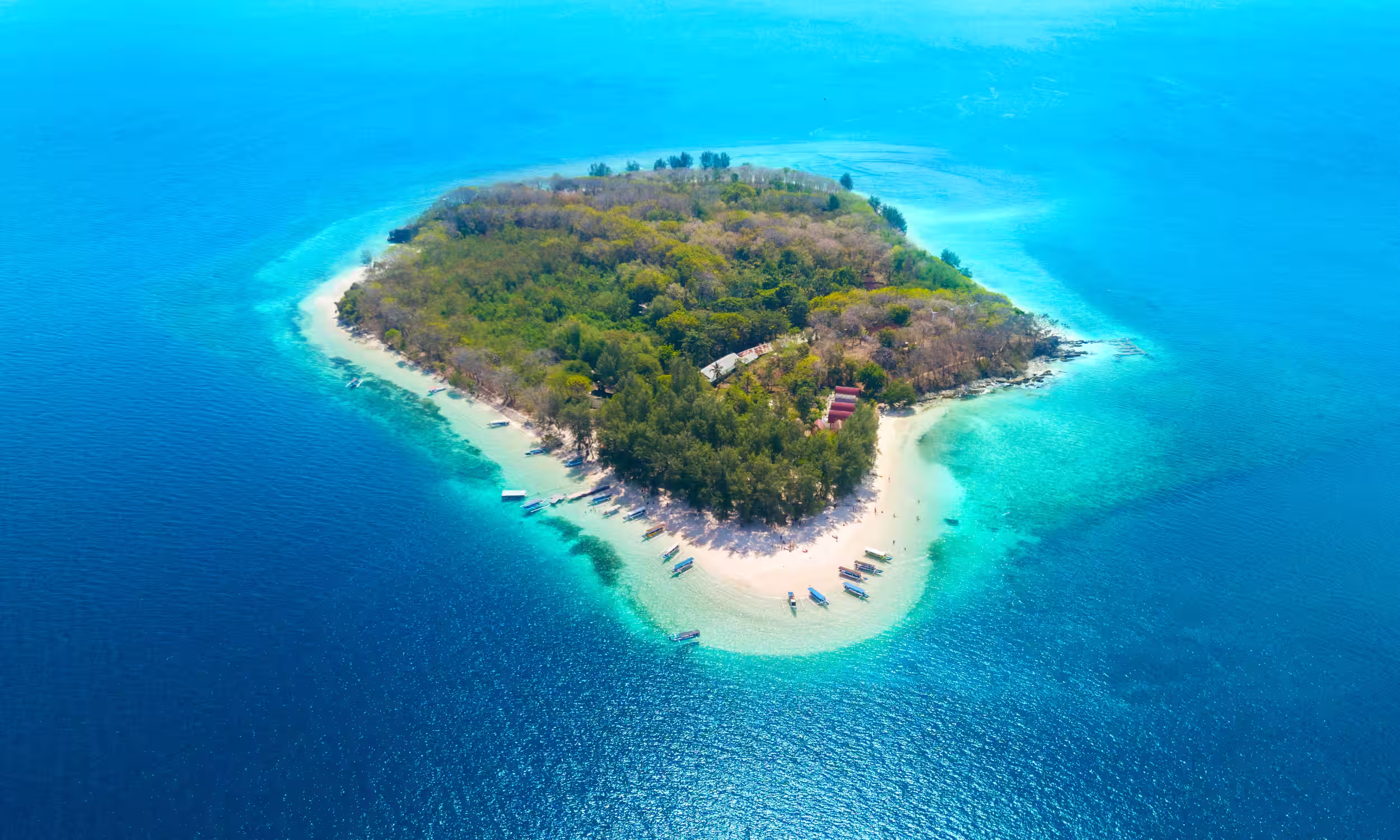 Top view of Gili Nanggu island surrounded by turquoise water, a secluded tropical escape near Lombok.