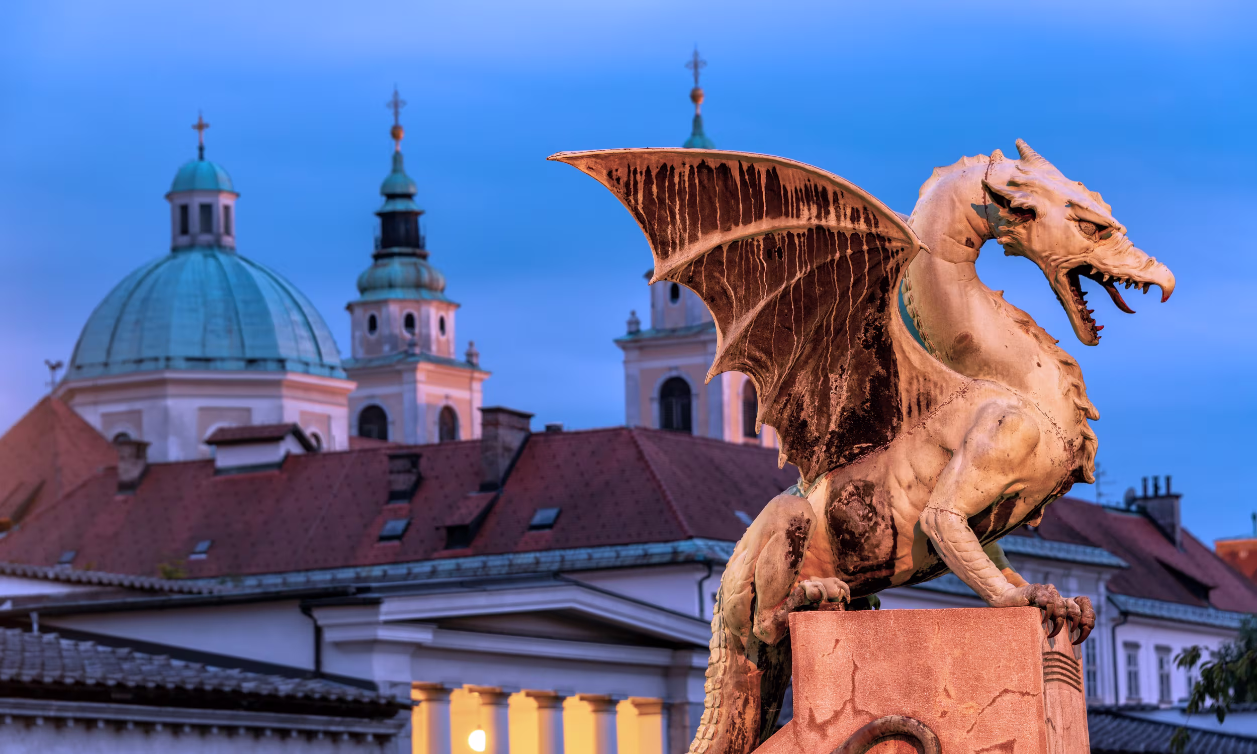 Dragon statue on Dragon Bridge in Ljubljana, an iconic symbol of the city and its identity.