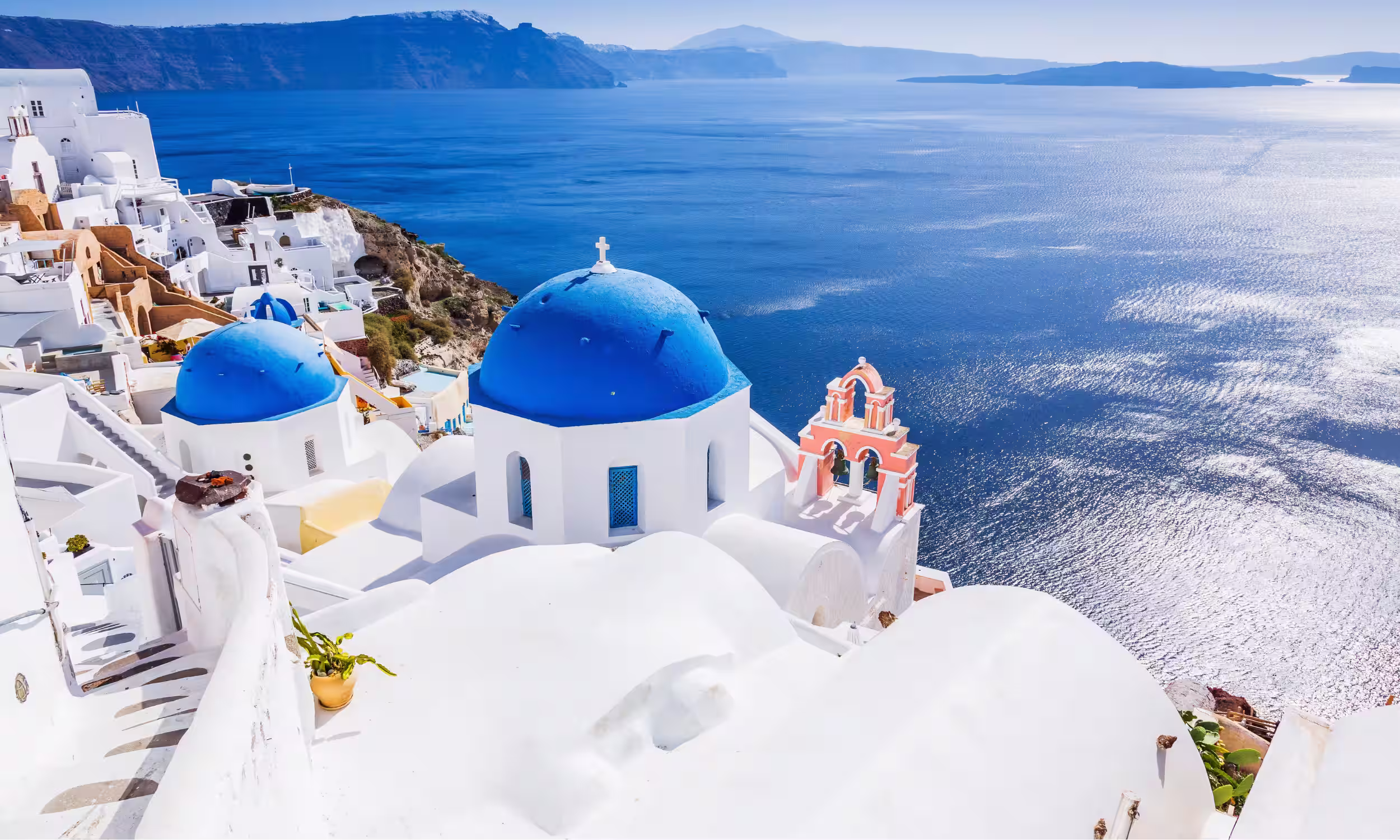 Romantic view of Santorini’s blue domes overlooking the Aegean Sea.