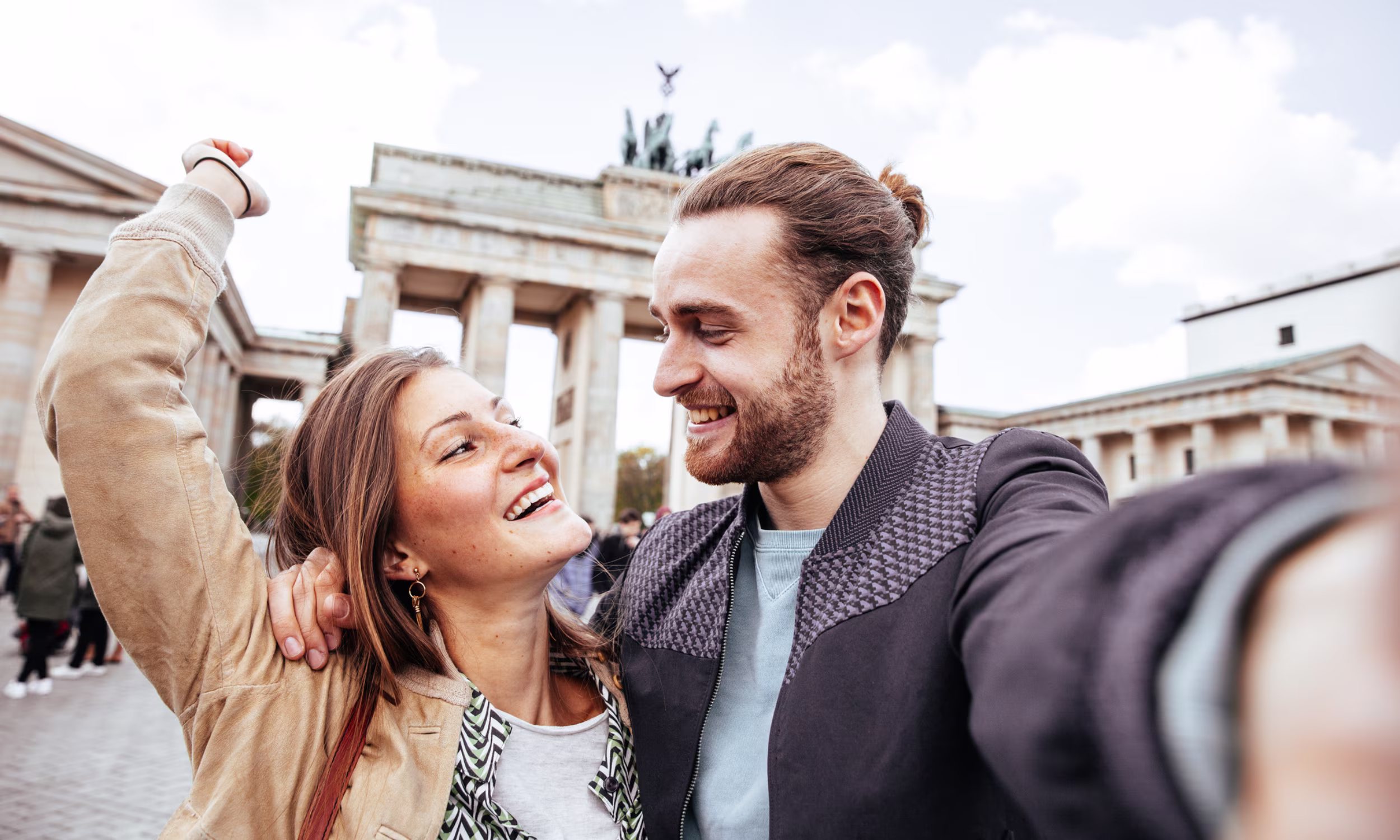 Couple near the Brandenburg Gate during a romantic trip to Berlin.