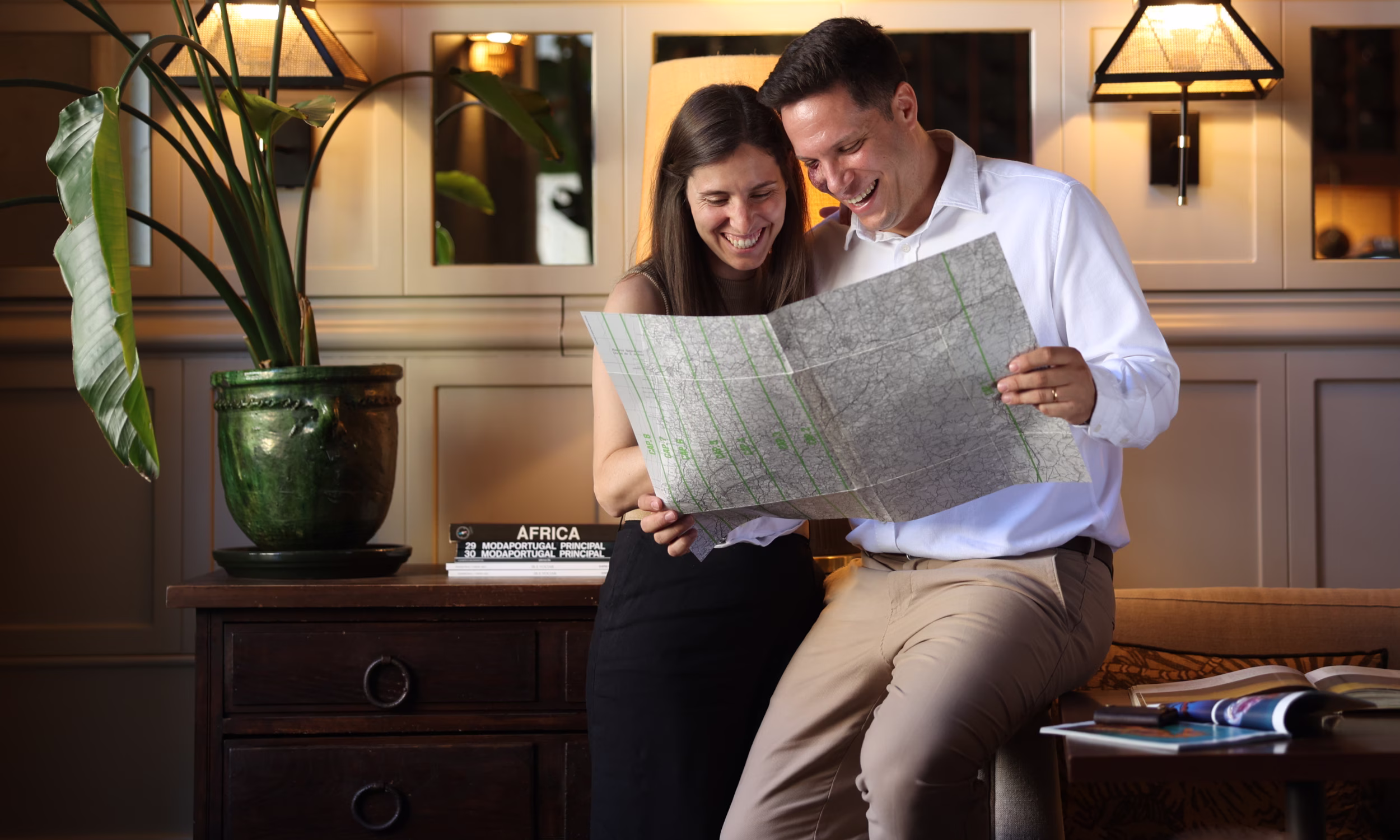 Joana and André planning a personalized honeymoon while reviewing a travel map.