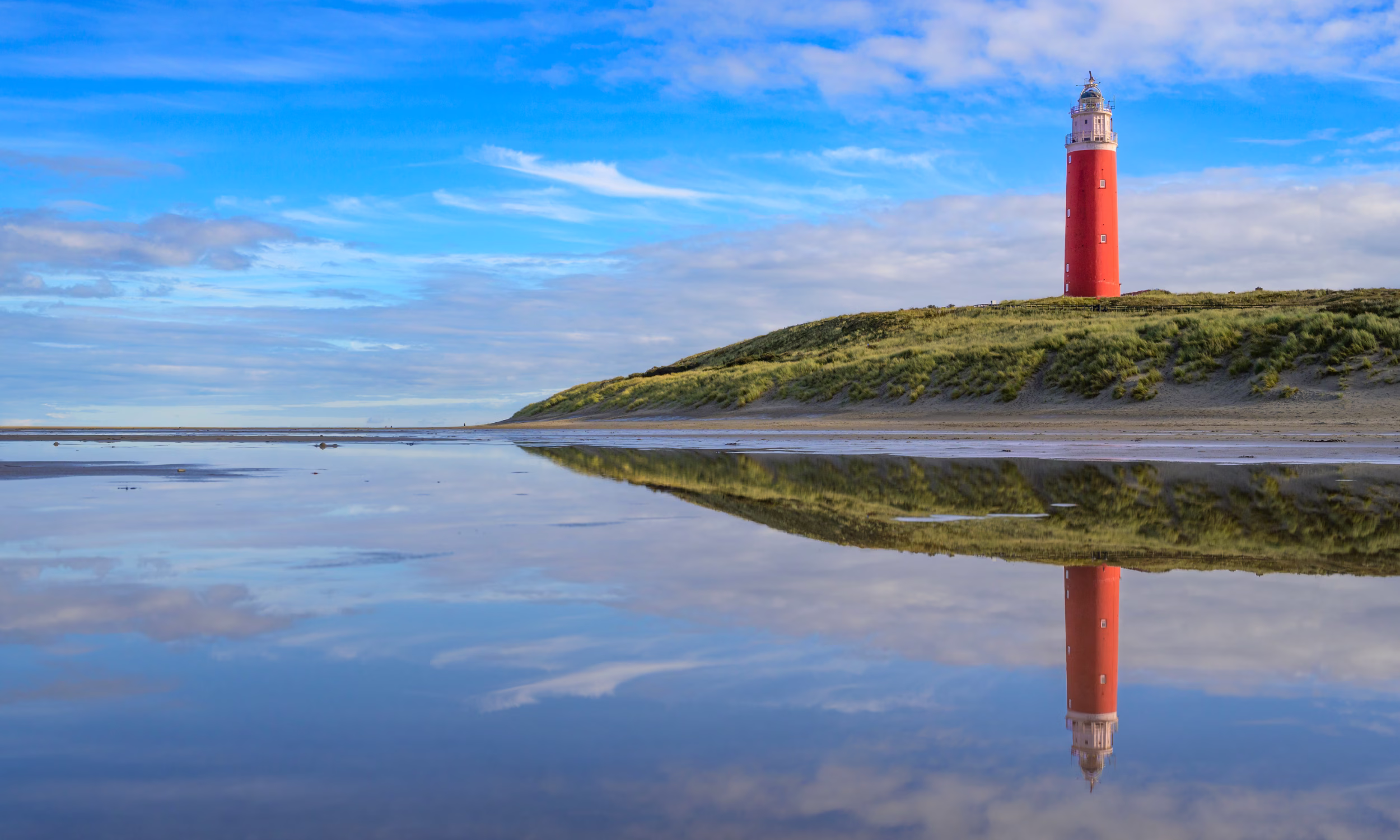 Texel lighthouse by the beach during a calm autumn afternoon in the Netherlands.