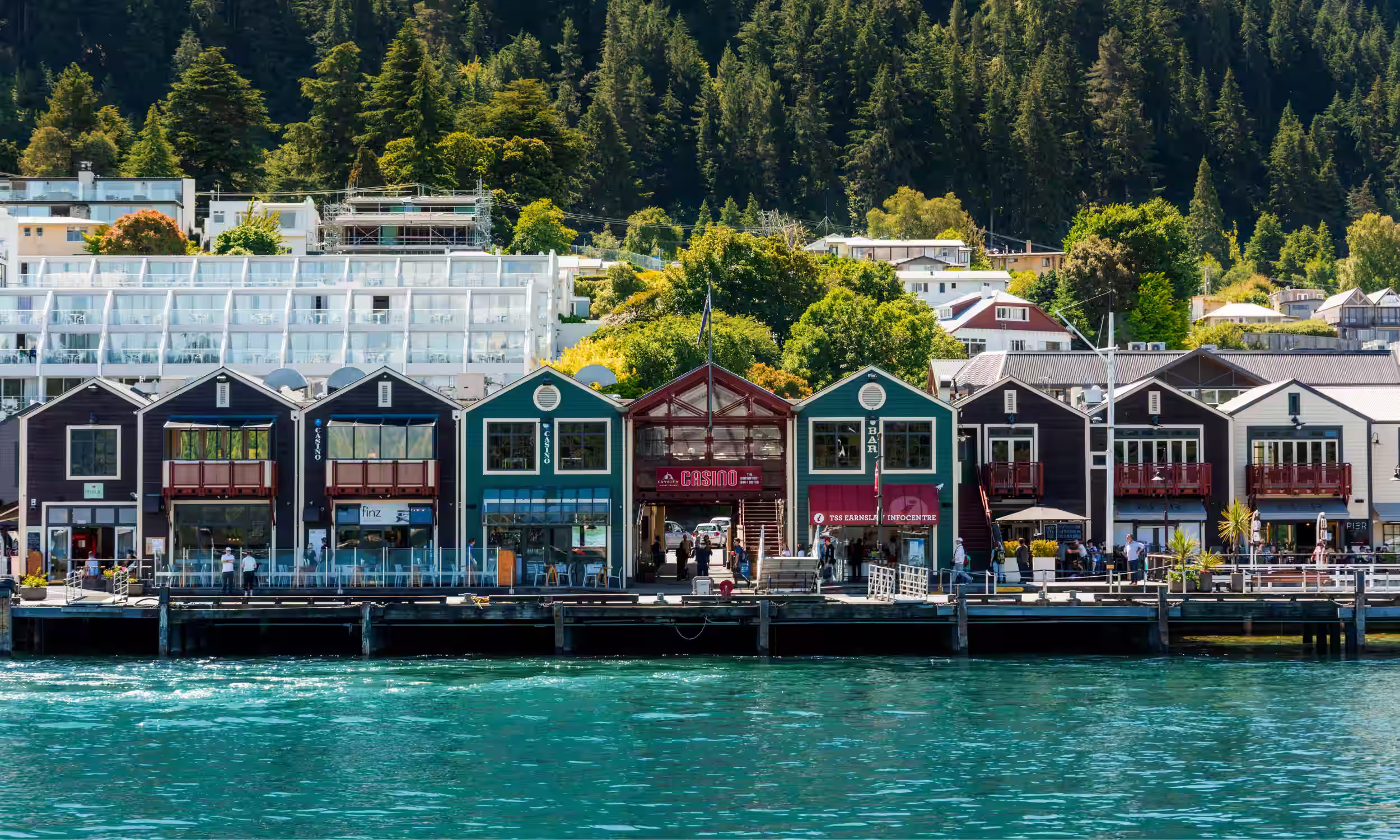 Queenstown waterfront with colorful buildings overlooking Lake Wakatipu.