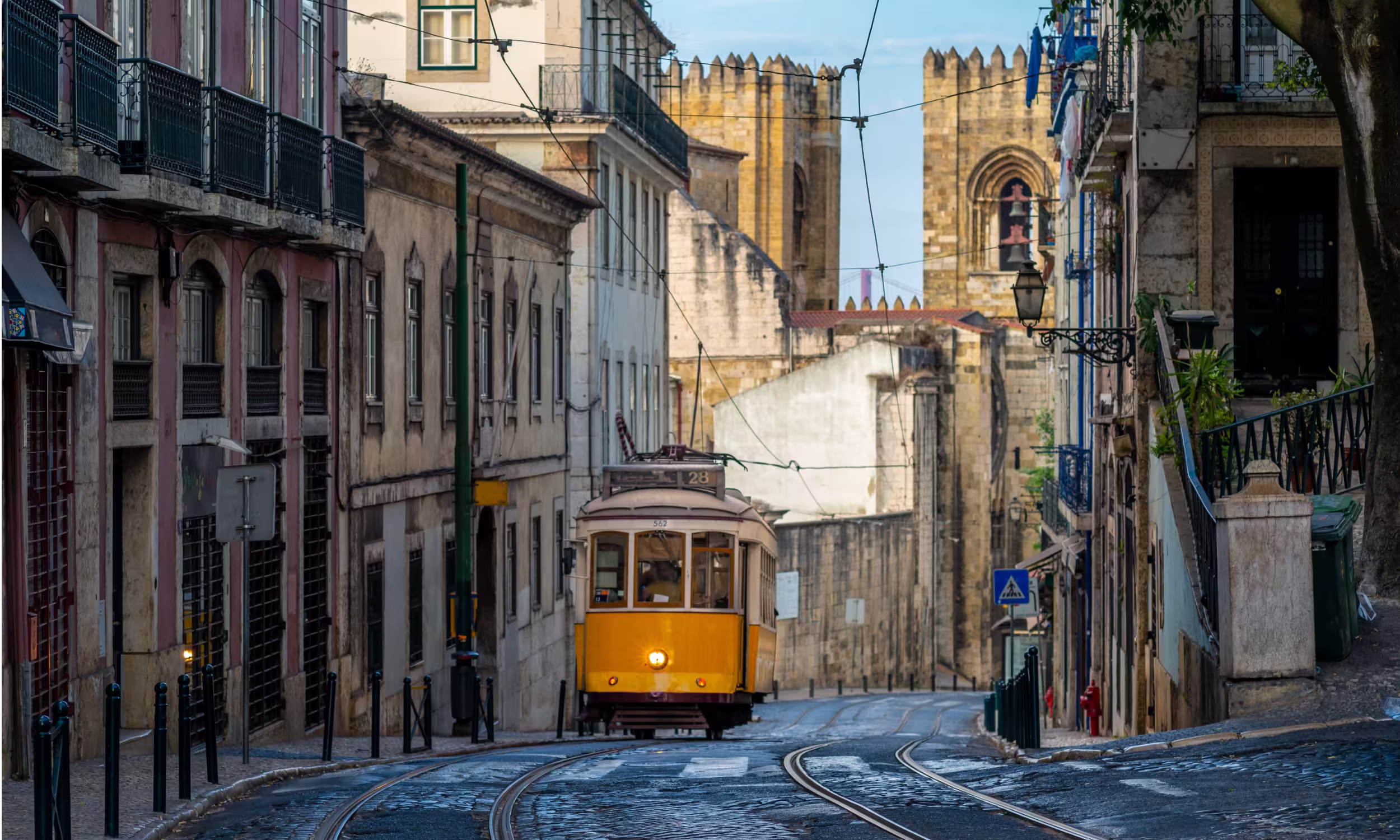 Historic Tram 28 traveling through the streets of Lisbon, Portugal.