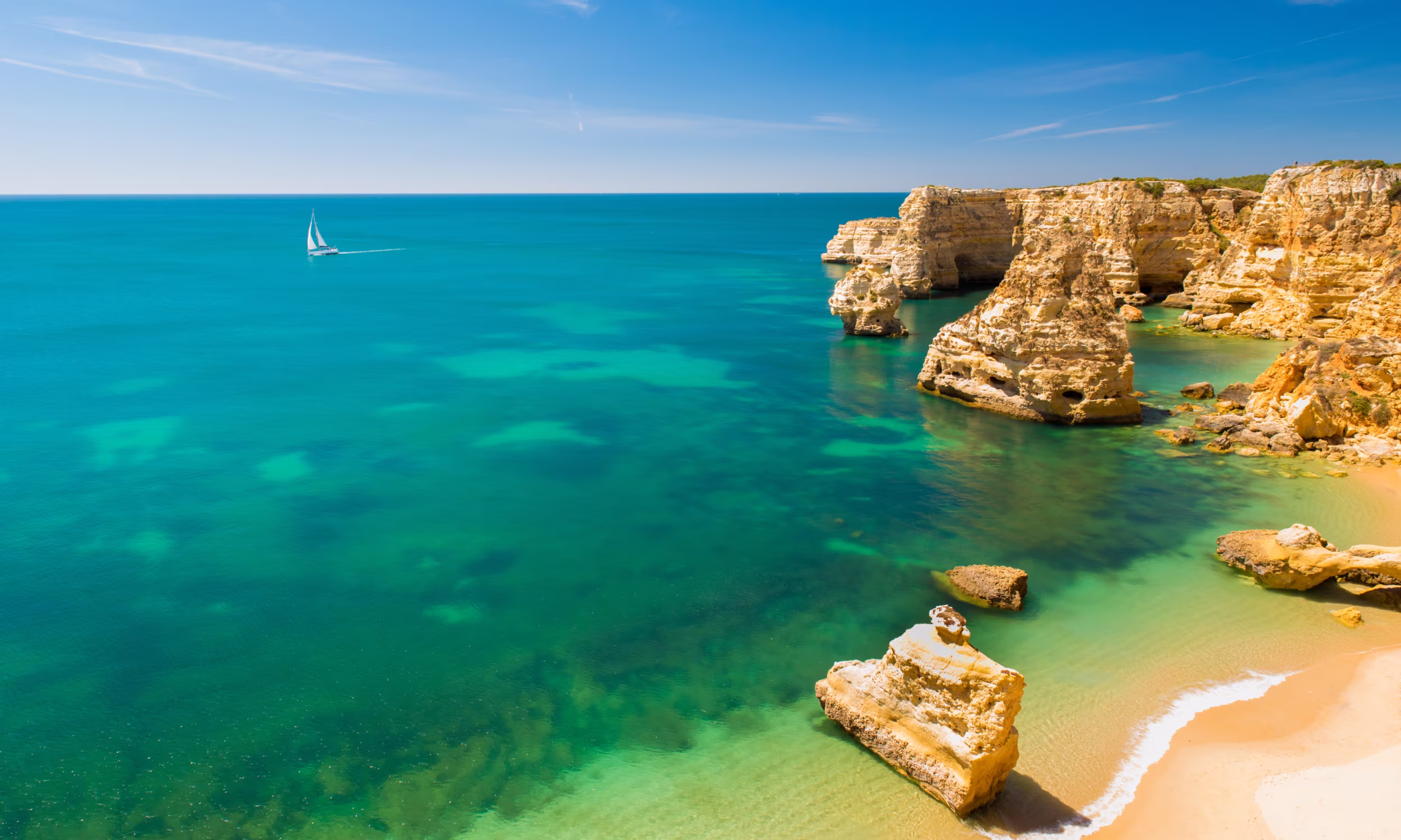 Praia da Marinha in Portugal's Algarve with golden cliffs and crystal clear waters.