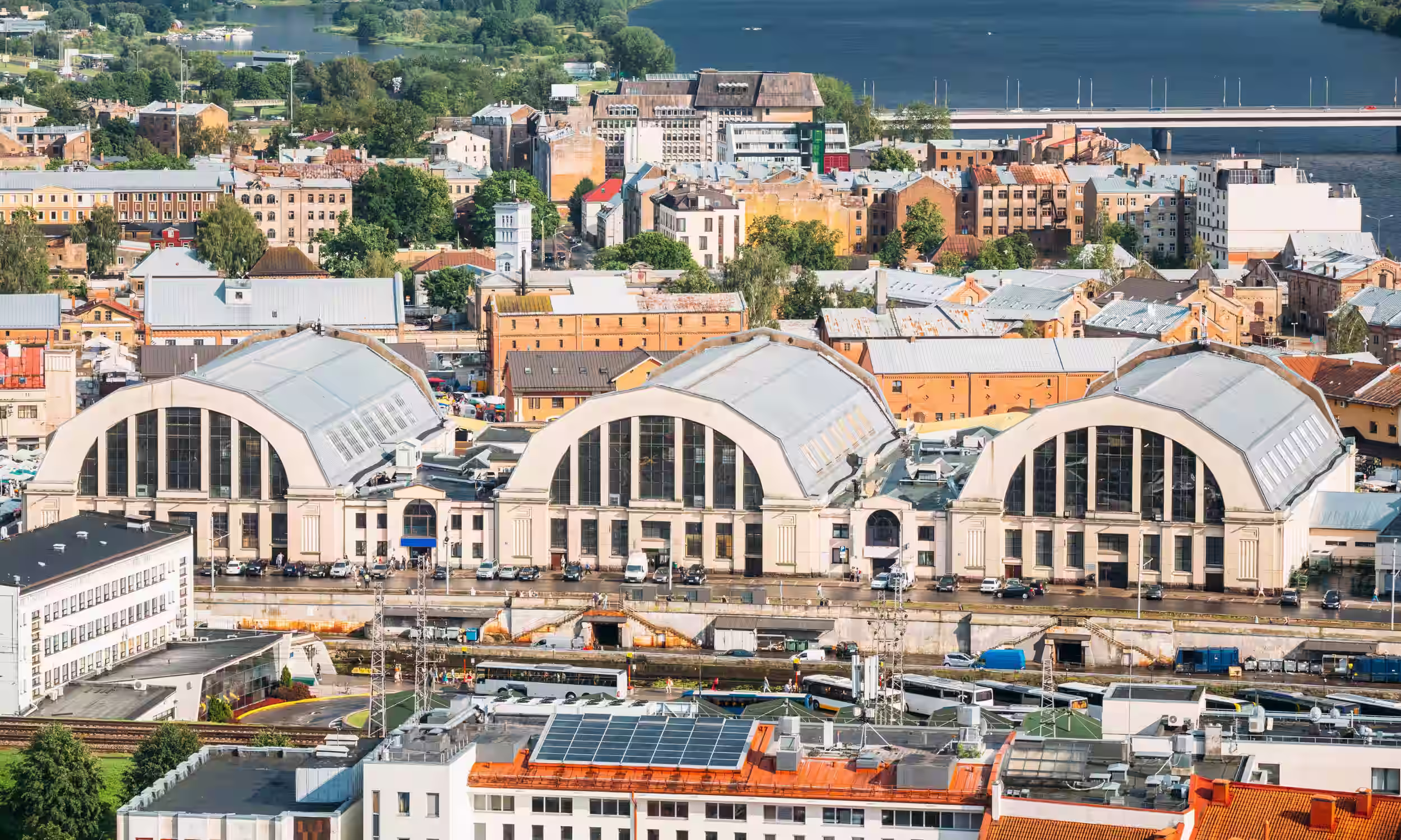 Aerial view of Riga Central Market and the surrounding city at sunset.
