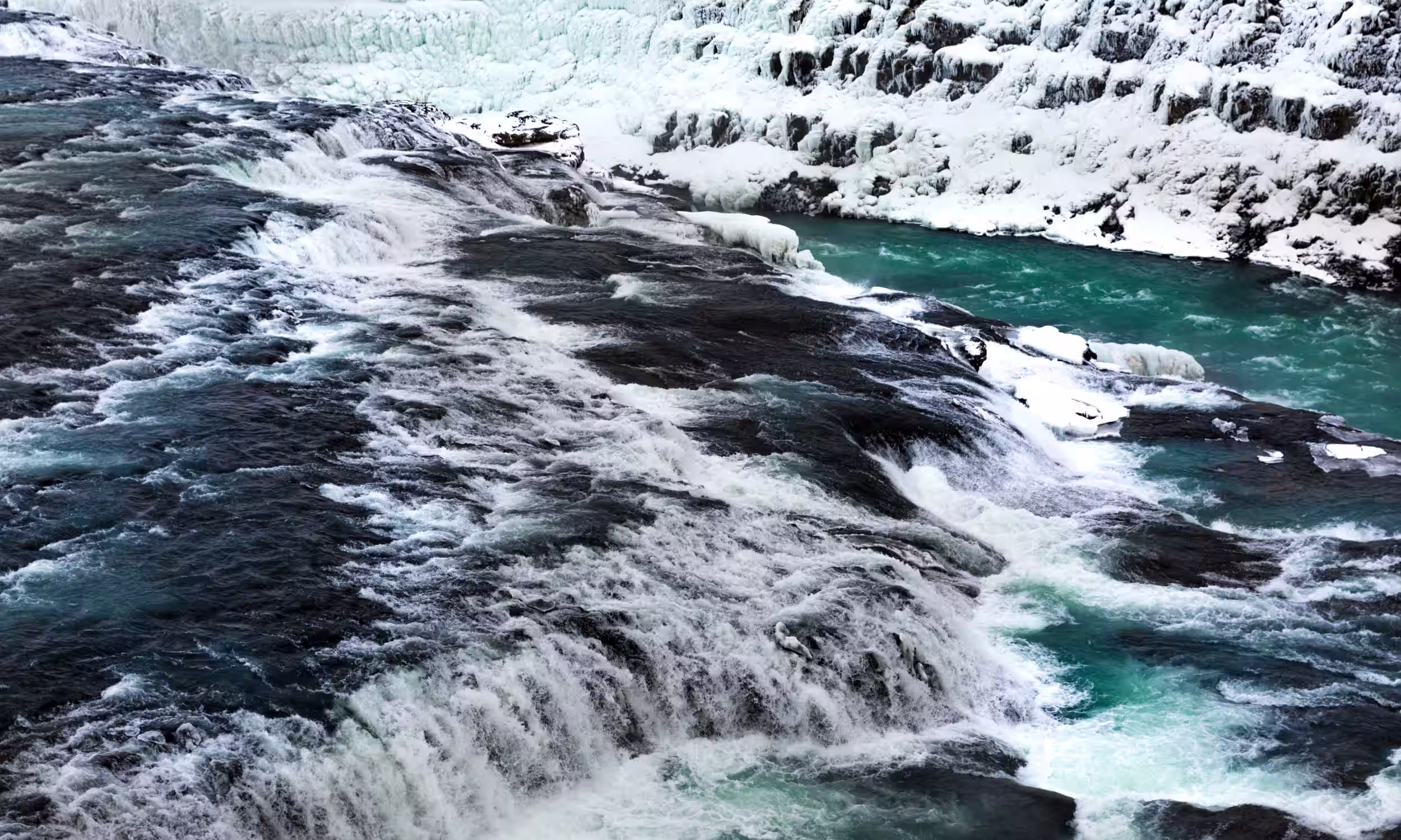 Gullfoss waterfall viewed from above as powerful water flows through the icy landscape of Iceland’s Golden Circle.