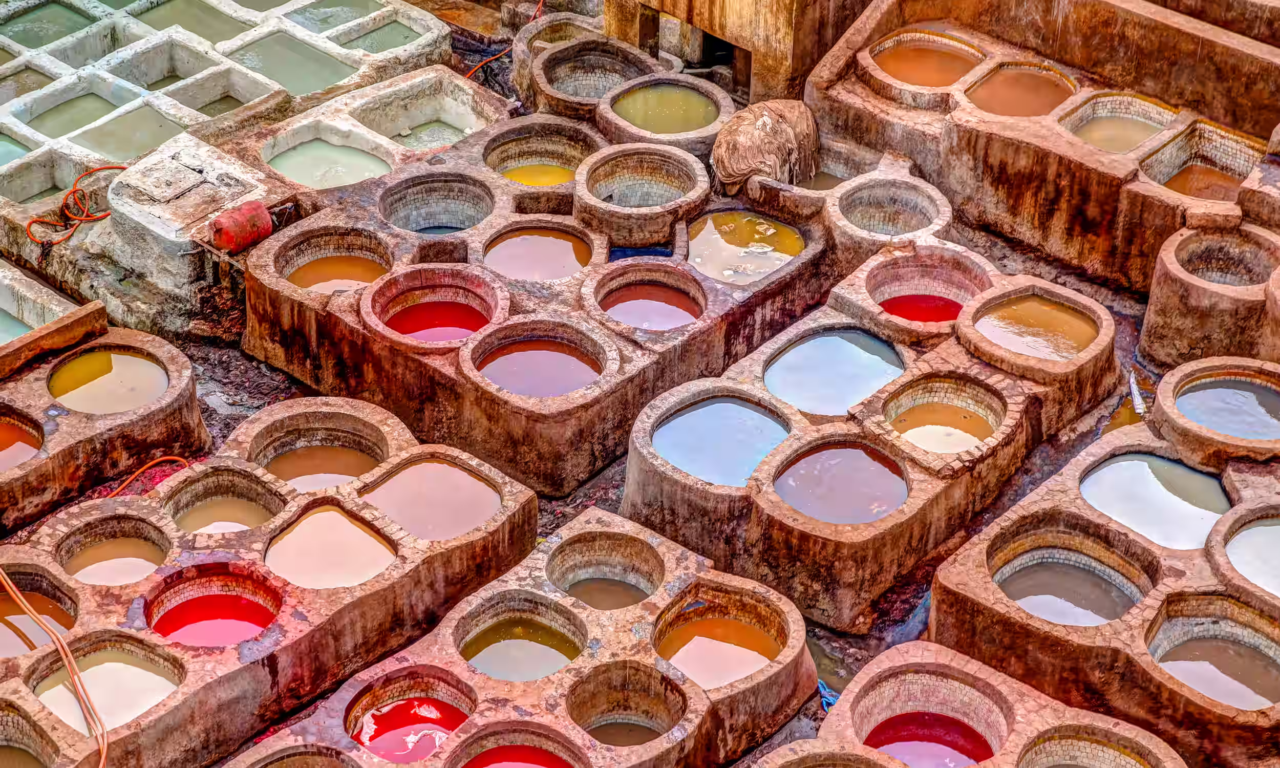 Traditional dyeing vats at Chouara Tannery in the Fes el Bali medina in Fez, Morocco.