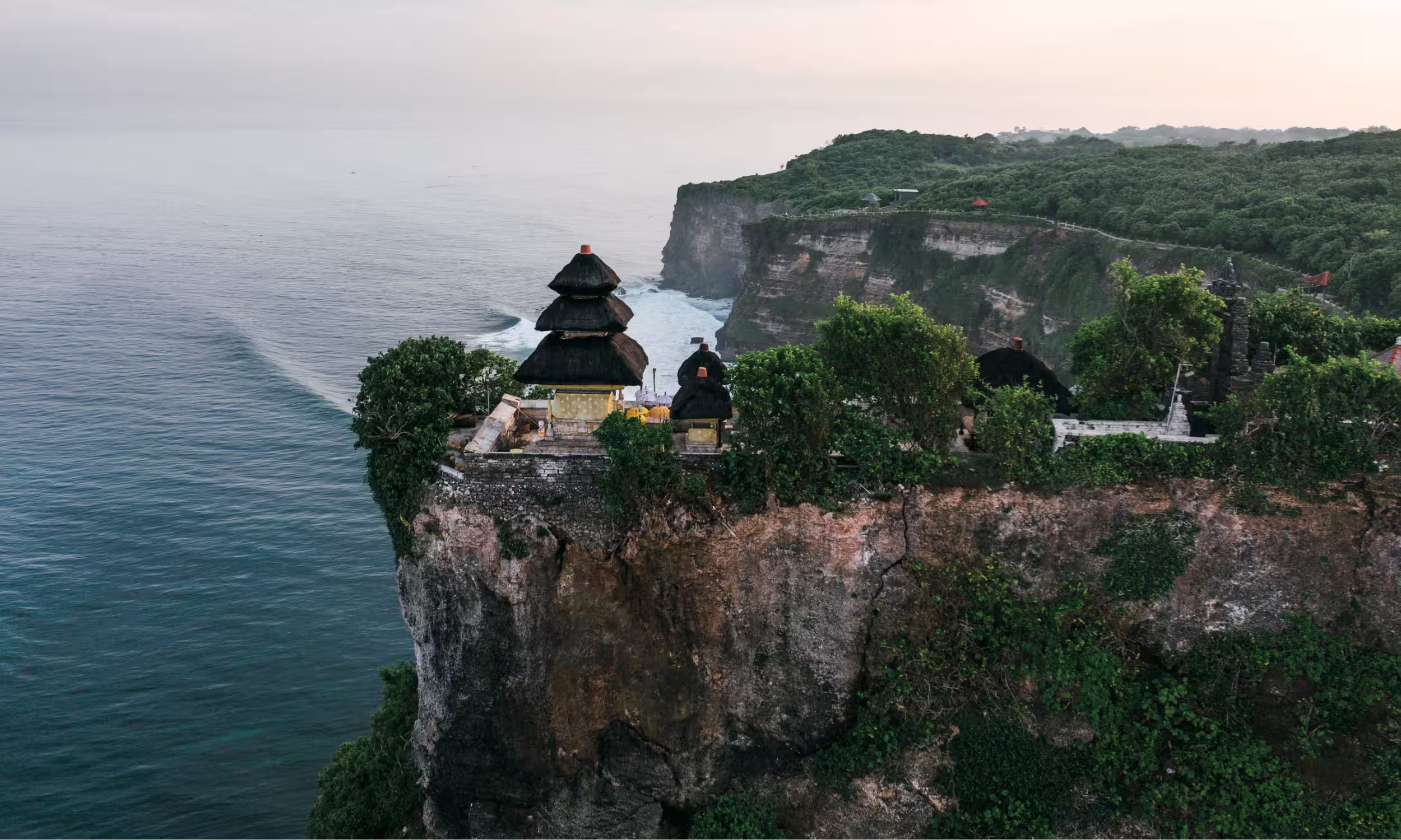 Uluwatu Temple perched on dramatic cliffs overlooking the Indian Ocean in Bali.