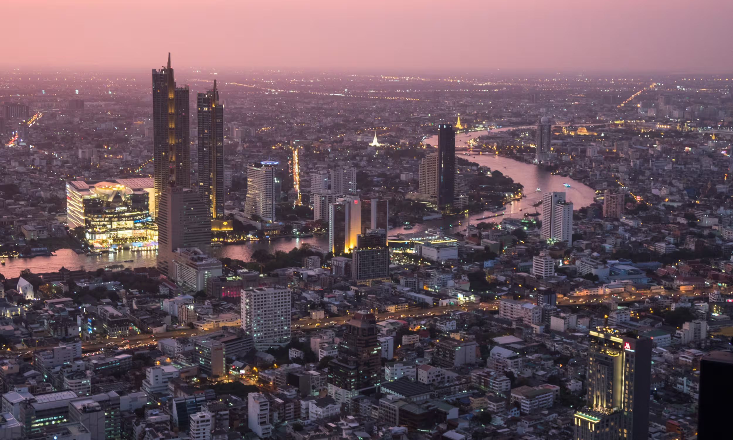 Panoramic view of Bangkok at sunset from the Mahanakhon SkyWalk in Thailand.